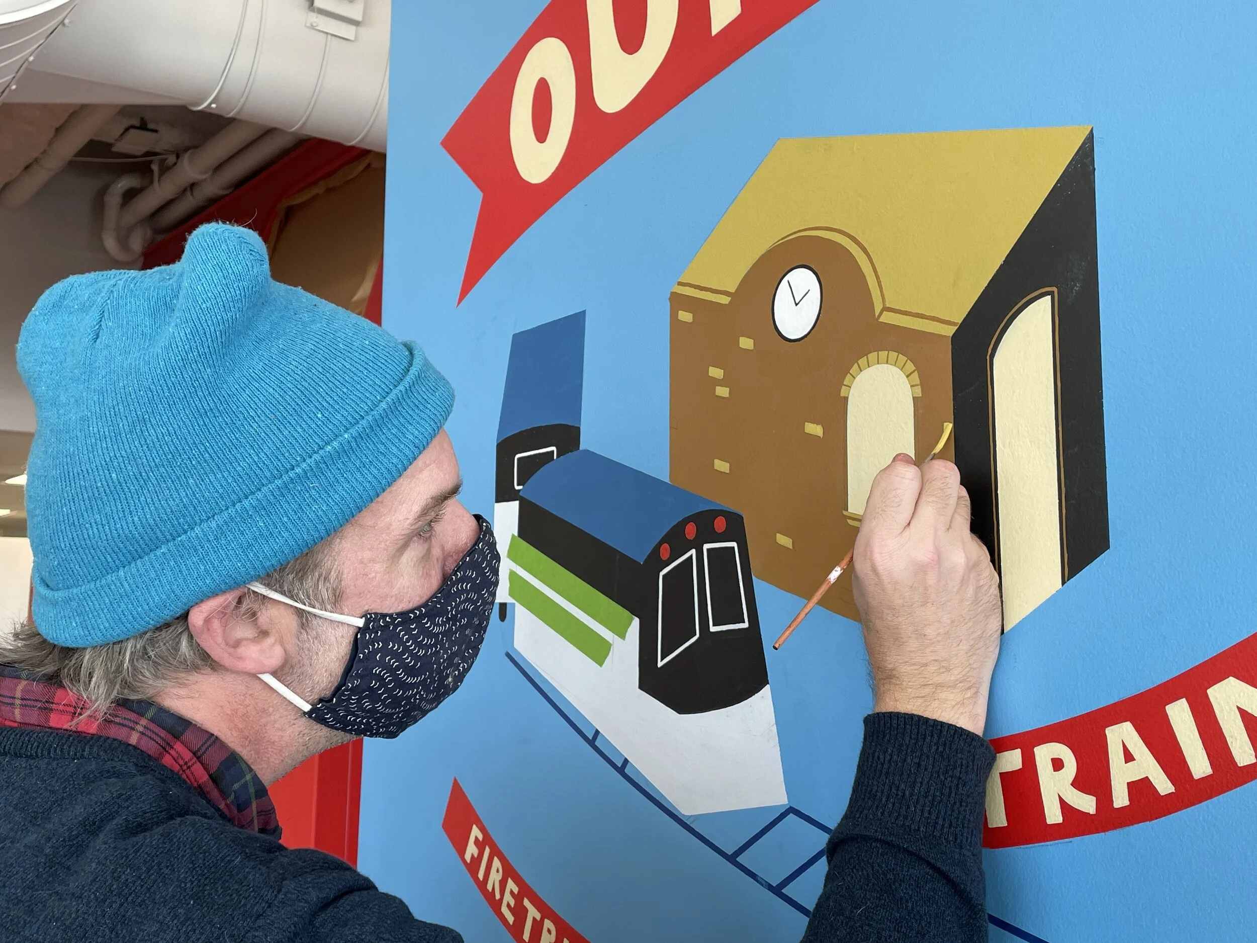 Patrick Corrigan paints one of the murals that he designed at the Children’s Museum & Theatre of Maine