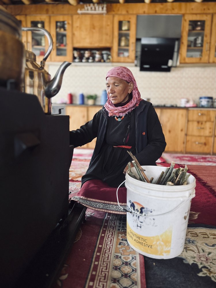  Disket Dorjay, the owner of Seeru Guest House in the village of Hemis Shukpachan in India, adds wood to her stove as she recounts finding her cow that had been killed by wolves. (Wyoming Truth photo by Matt Stirn) 