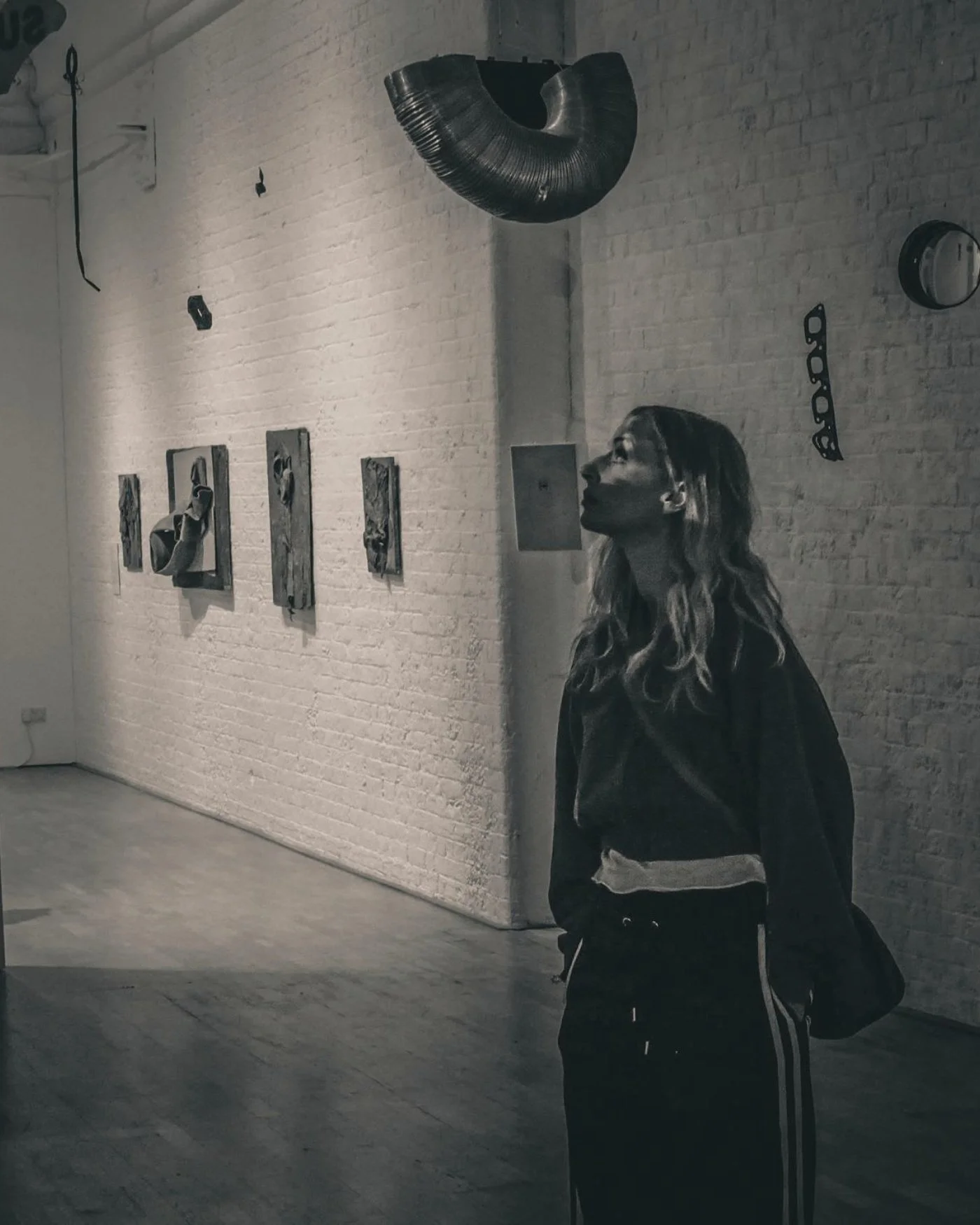 Gabs Brown, the writer and yoga teacher, looking up to the light in an art gallery.