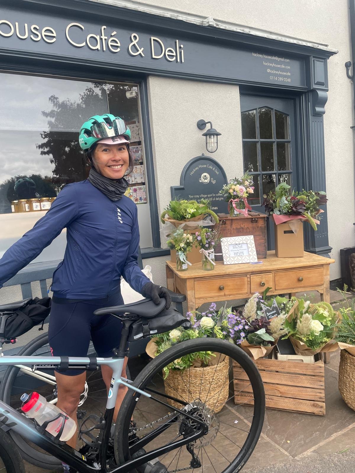 Tammy and her bike in front of a café
