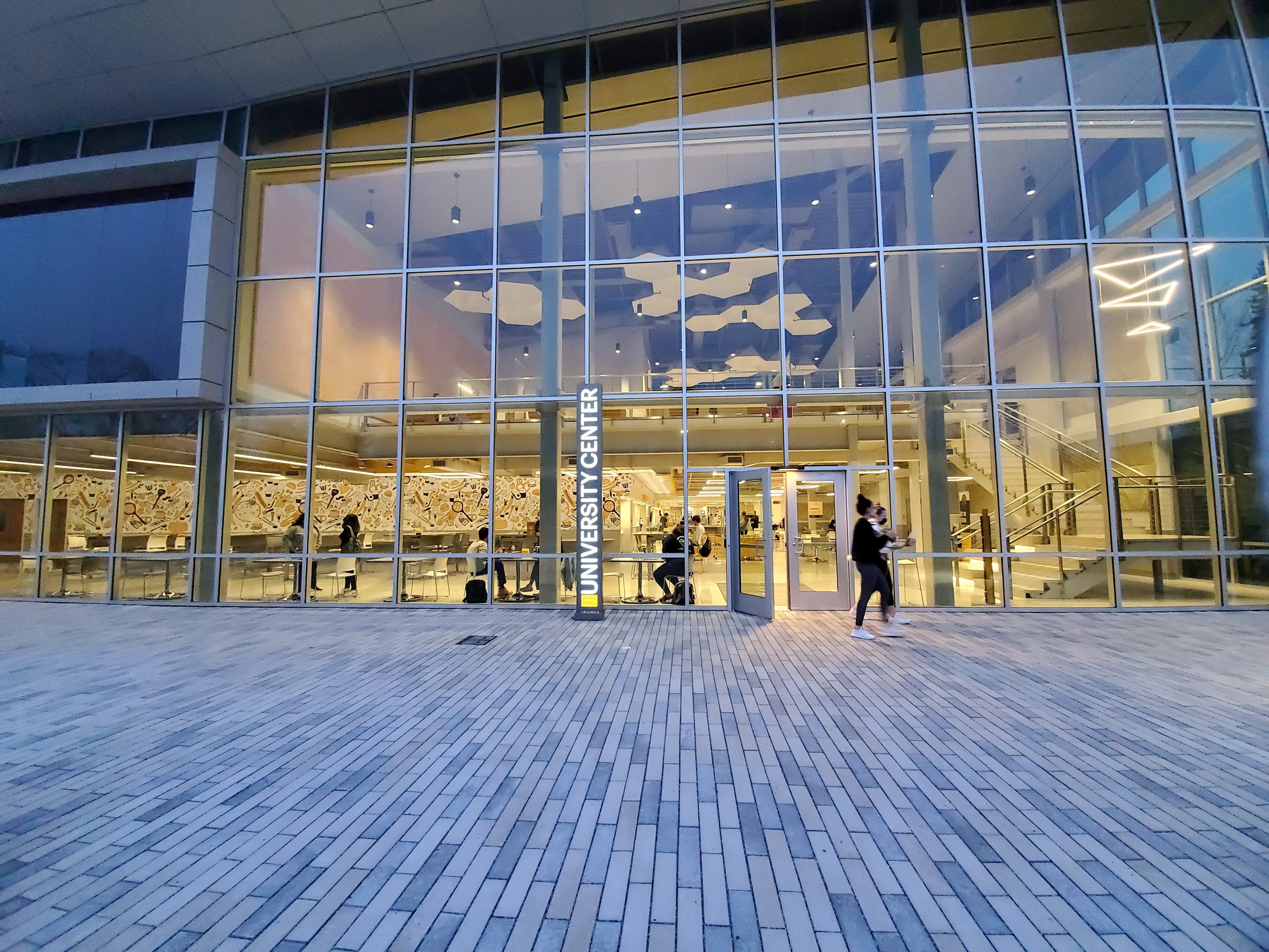 A view of the University Center entrance at twilight.