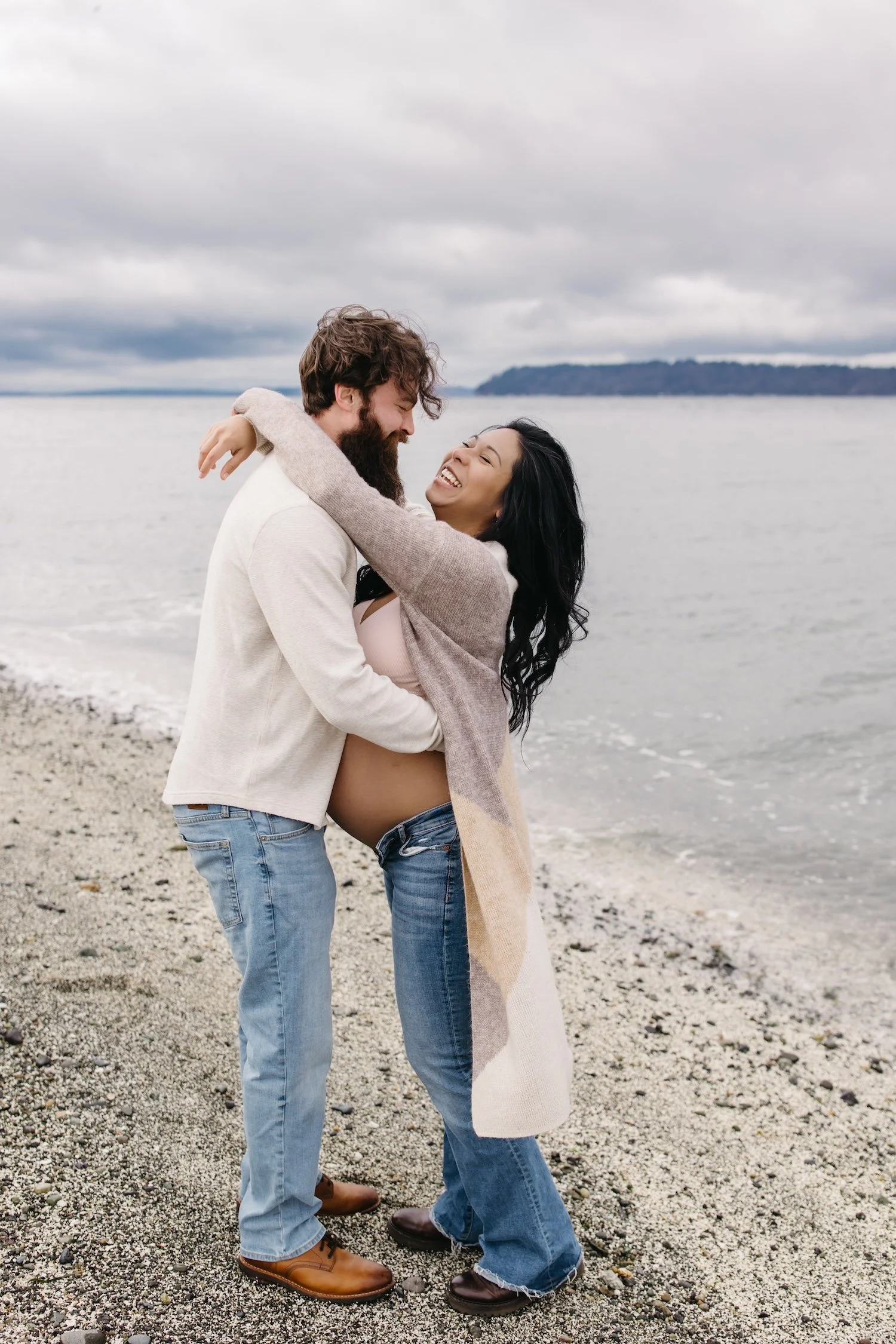 Playful Mukilteo beach maternity session with laughter