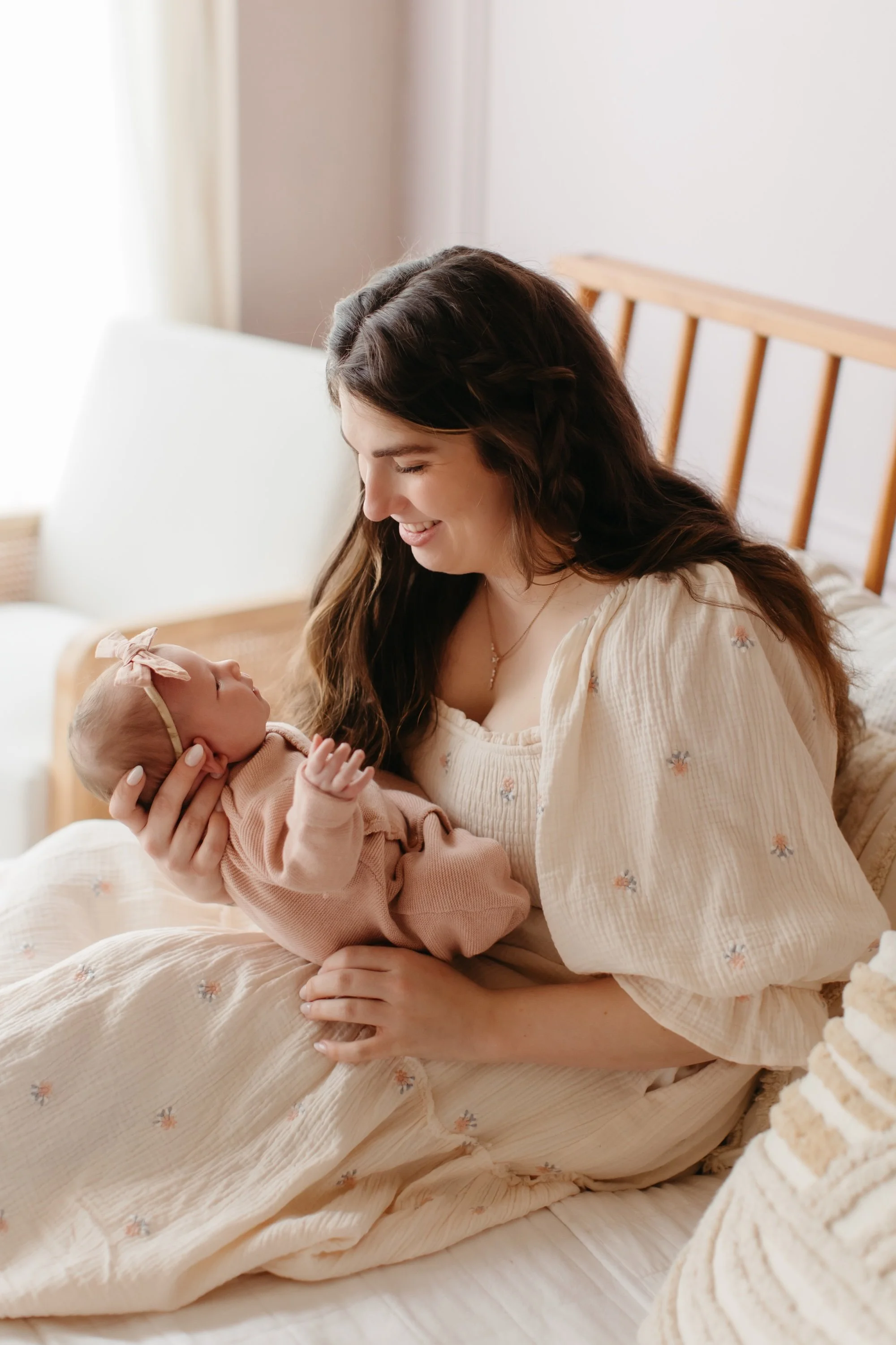 New mom holding baby in a bright Seattle studio space