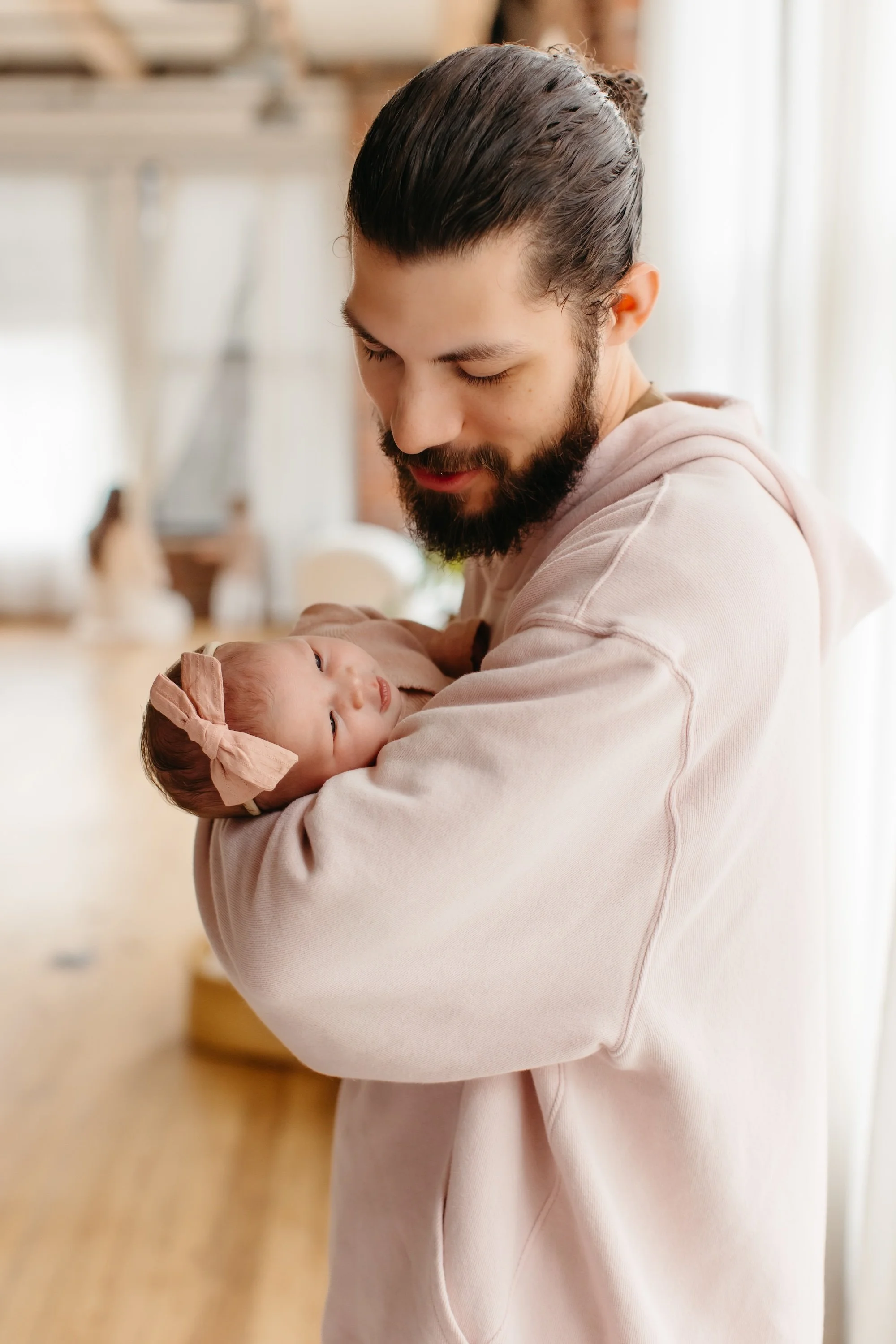 Dad holding a baby during a newborn lifestyle session