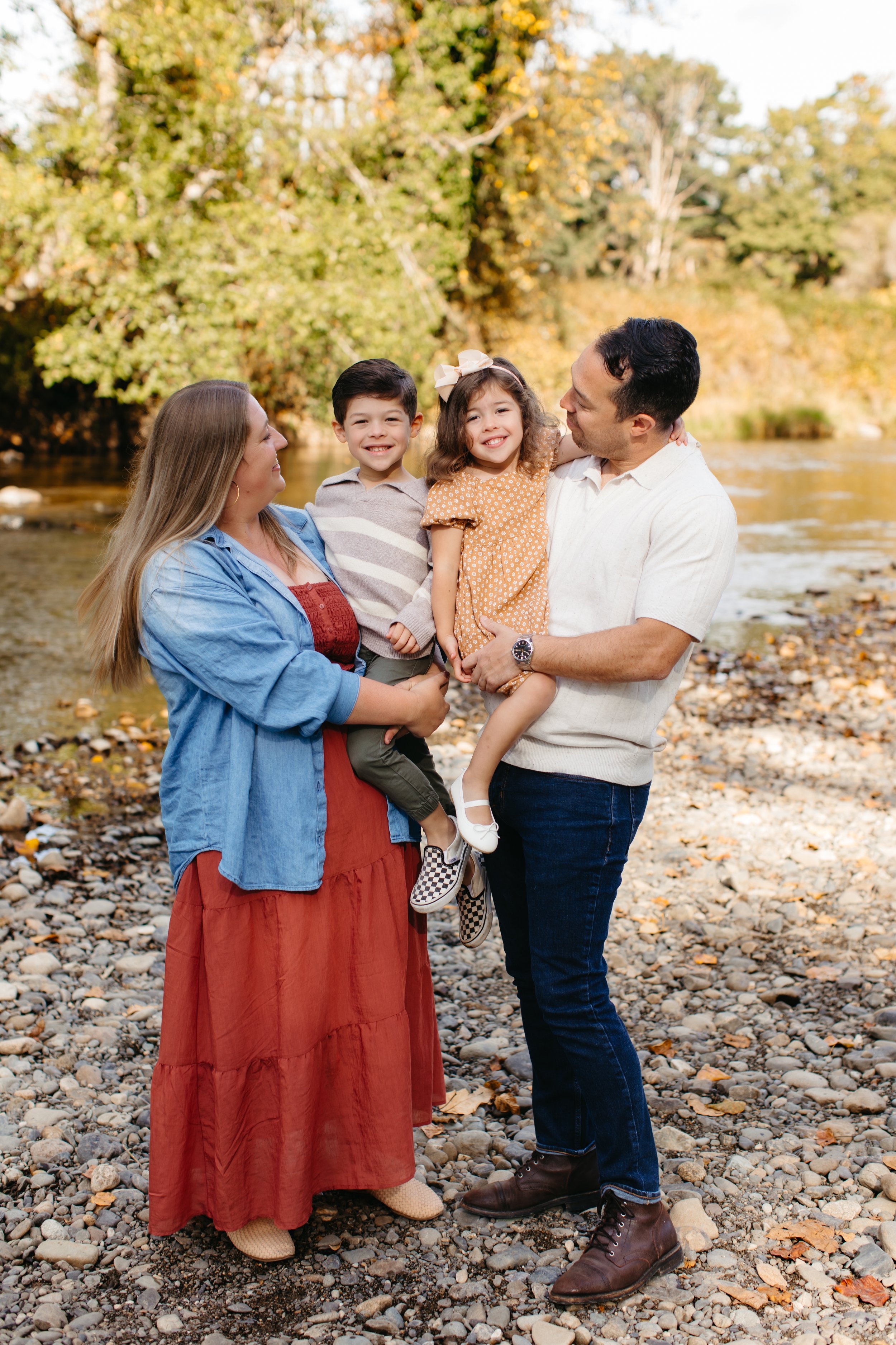 fall family photo with young kids at river
