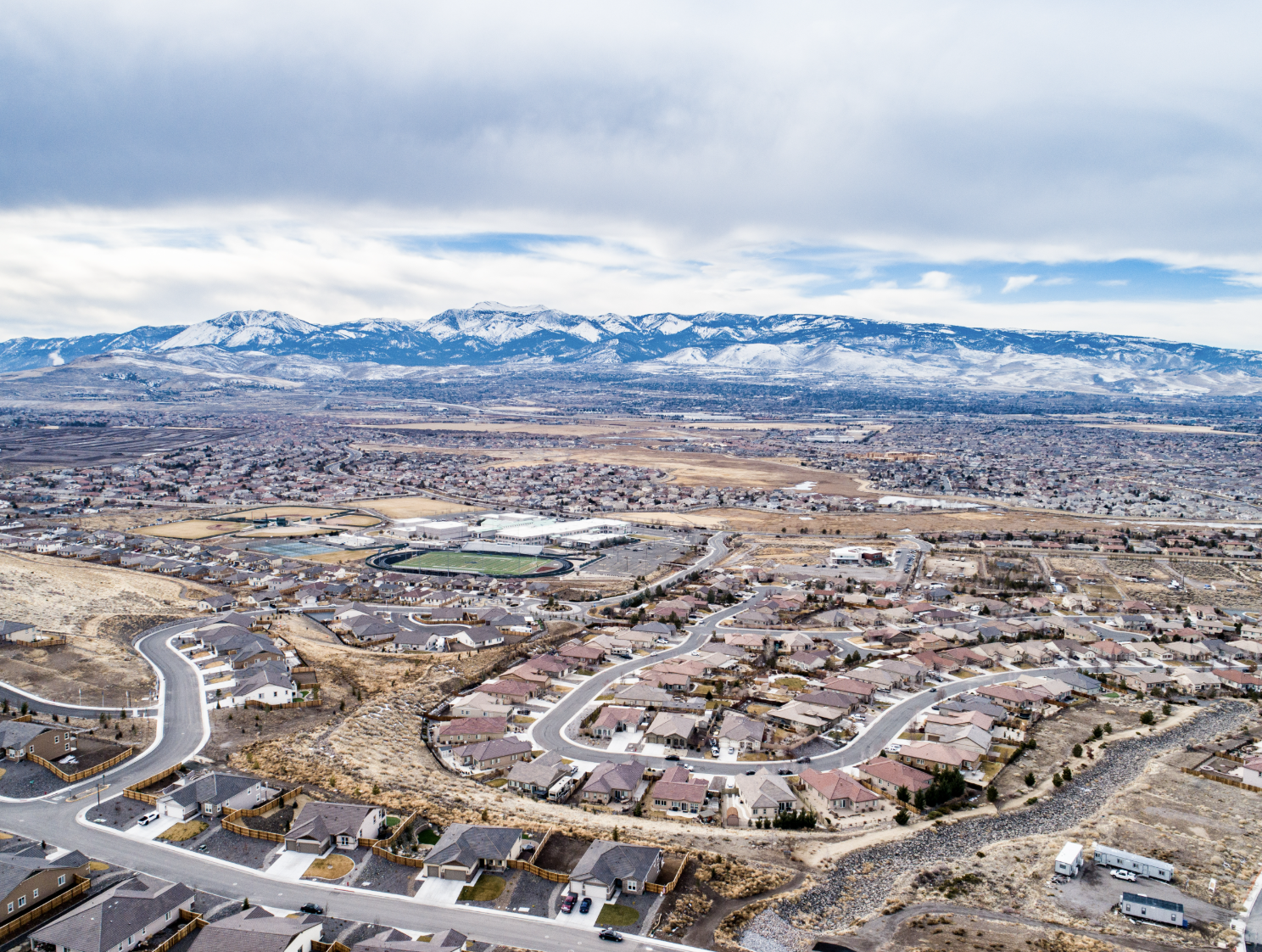 Aerial view of South Reno neighborhood with Sierra Nevada mountains in the background