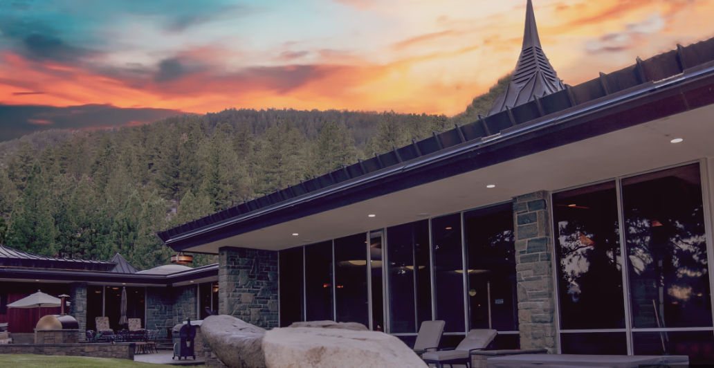 Luxury estate home in Washoe Valley Nevada surrounded by pine trees at sunset