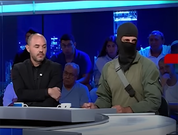   A masked Israeli soldier accused of abusing Palestinian detainees at the Sde Teiman facility appears on live television to defend his actions, turning allegations of torture into a televised spectacle.  