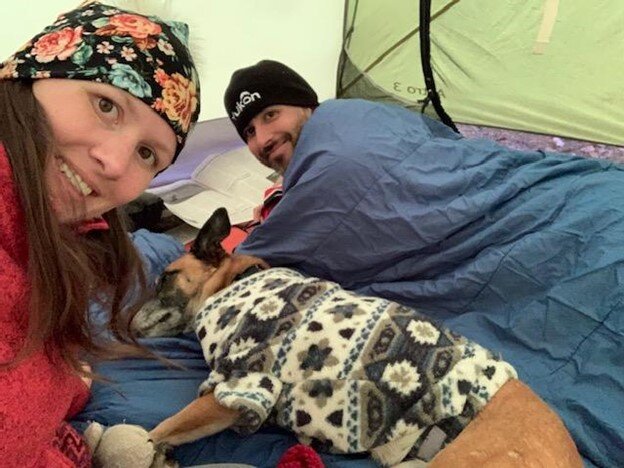 Trying to stay warm on the wet and chilly evening in our tent.