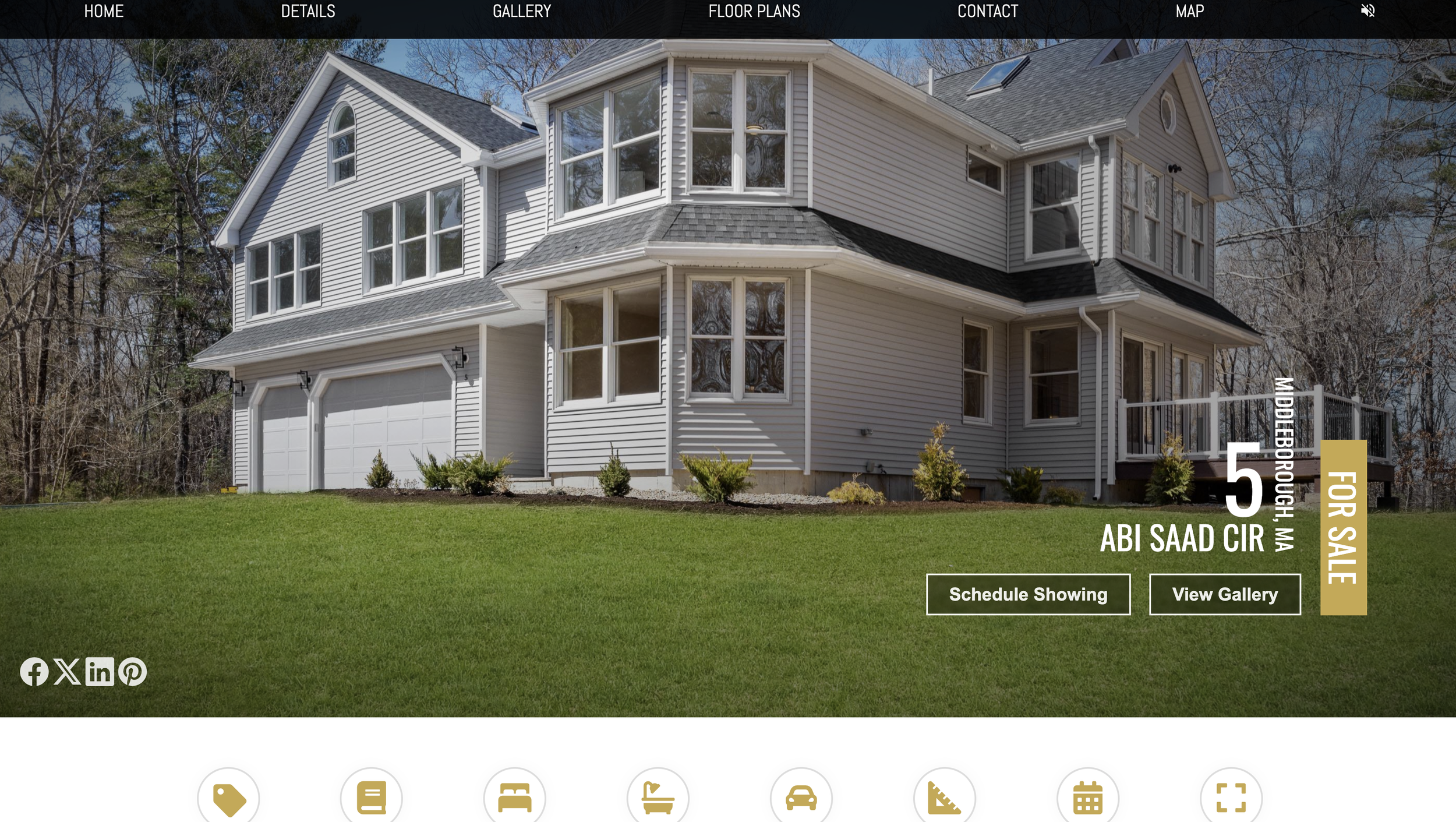 A large white two-story house with multiple gabled roofs and numerous windows, surrounded by a well-maintained lawn and trees in the background.