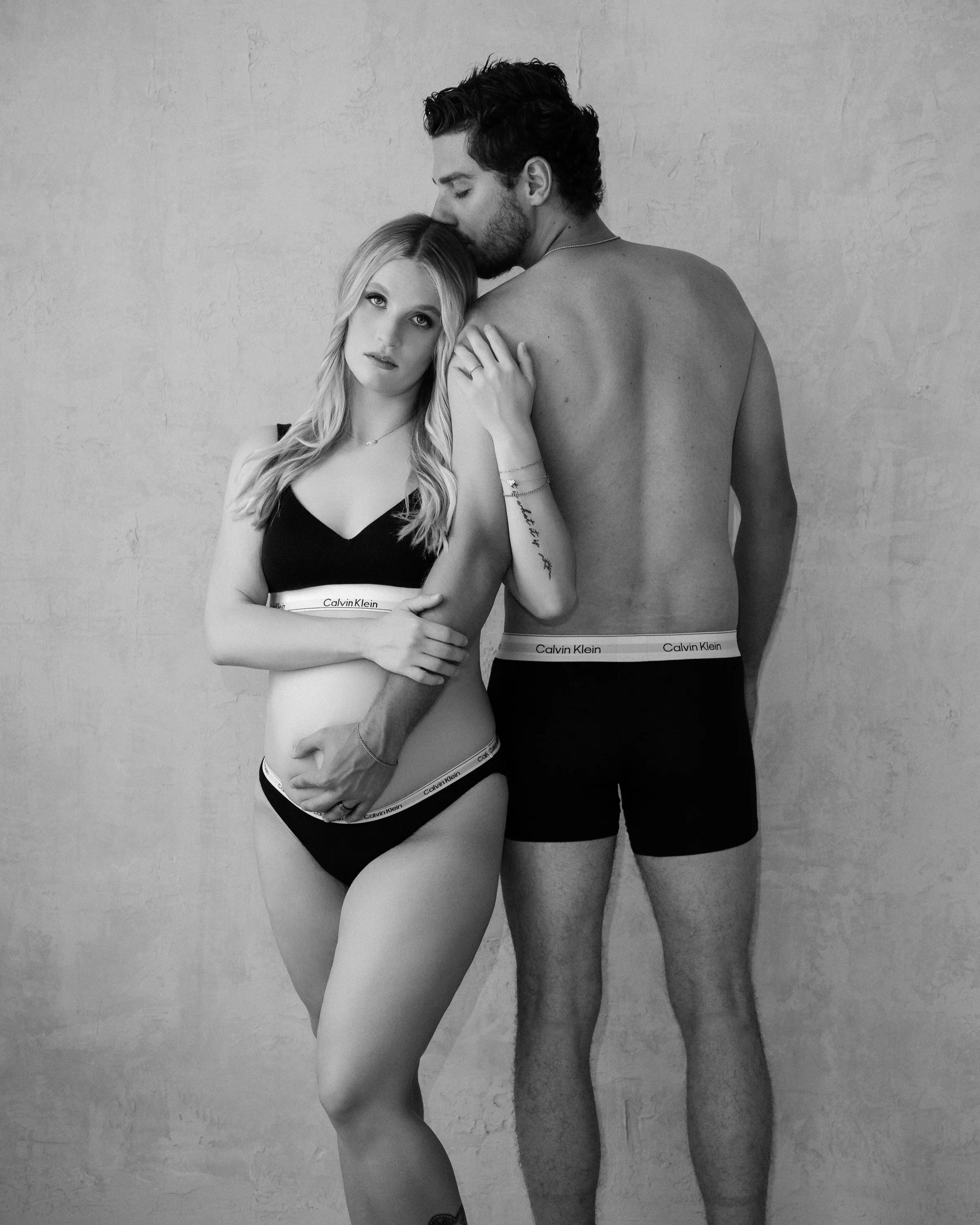 A cozy couples Calvin Klein maternity session at our private Round Rock studio near Austin, Texas
