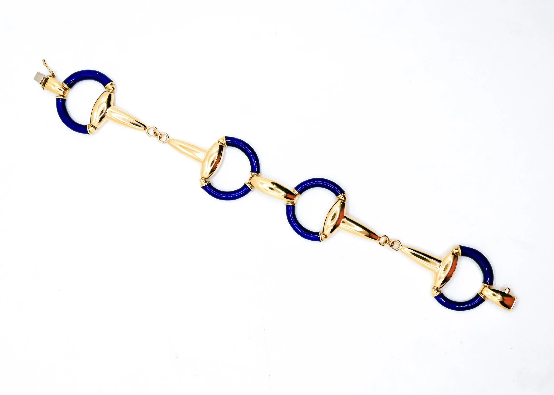 A close-up of a gold and blue linked necklace or bracelet on a white background.
