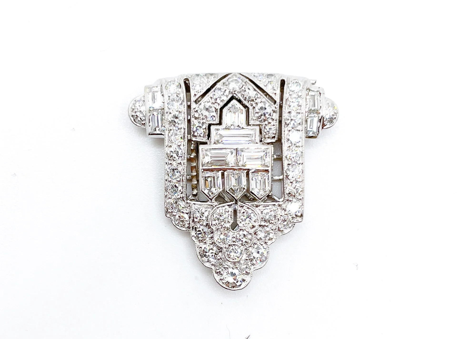 A diamond ring with intricate design and multiple diamonds on a white background.