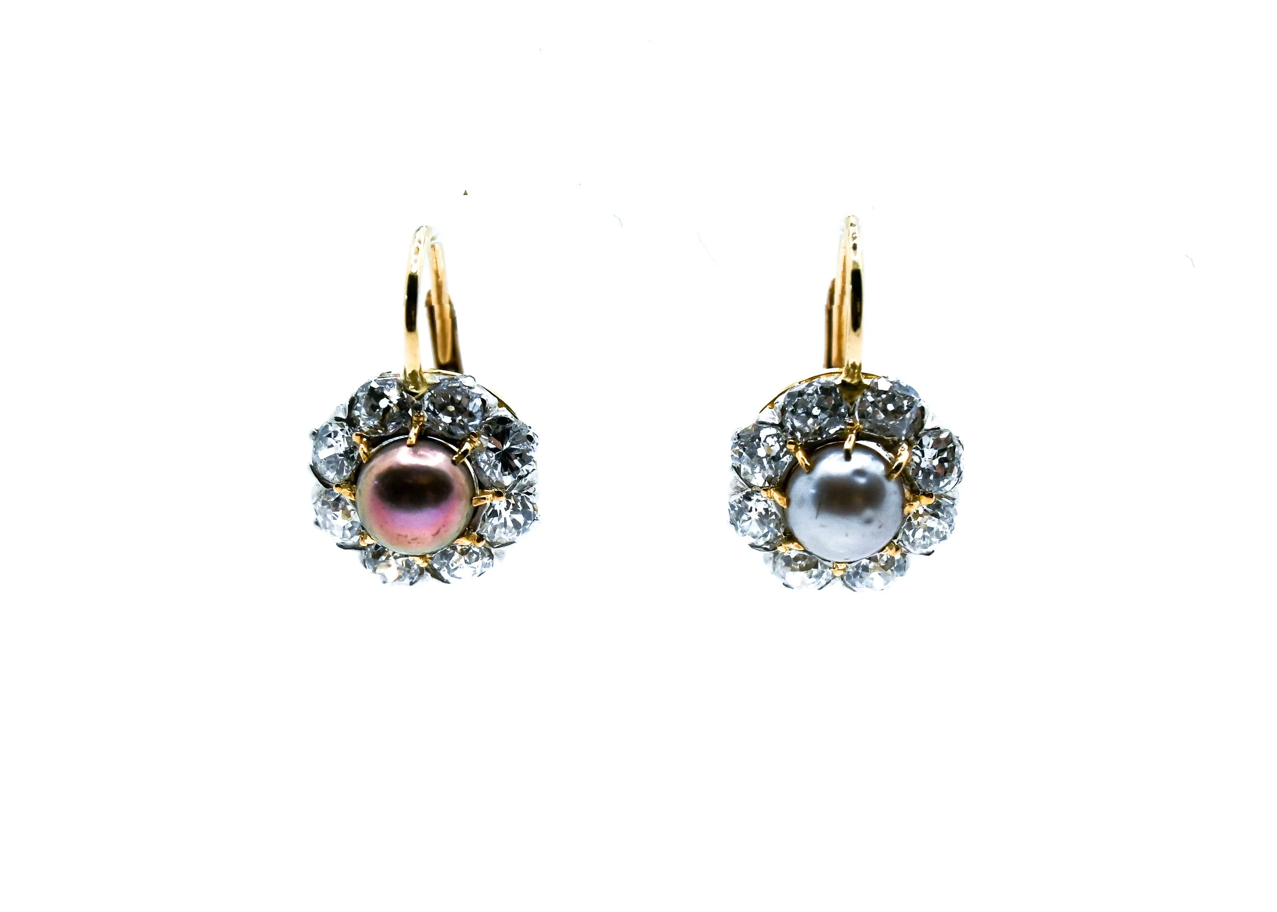 Pair of gold earrings with central pearls surrounded by diamonds on a white background.