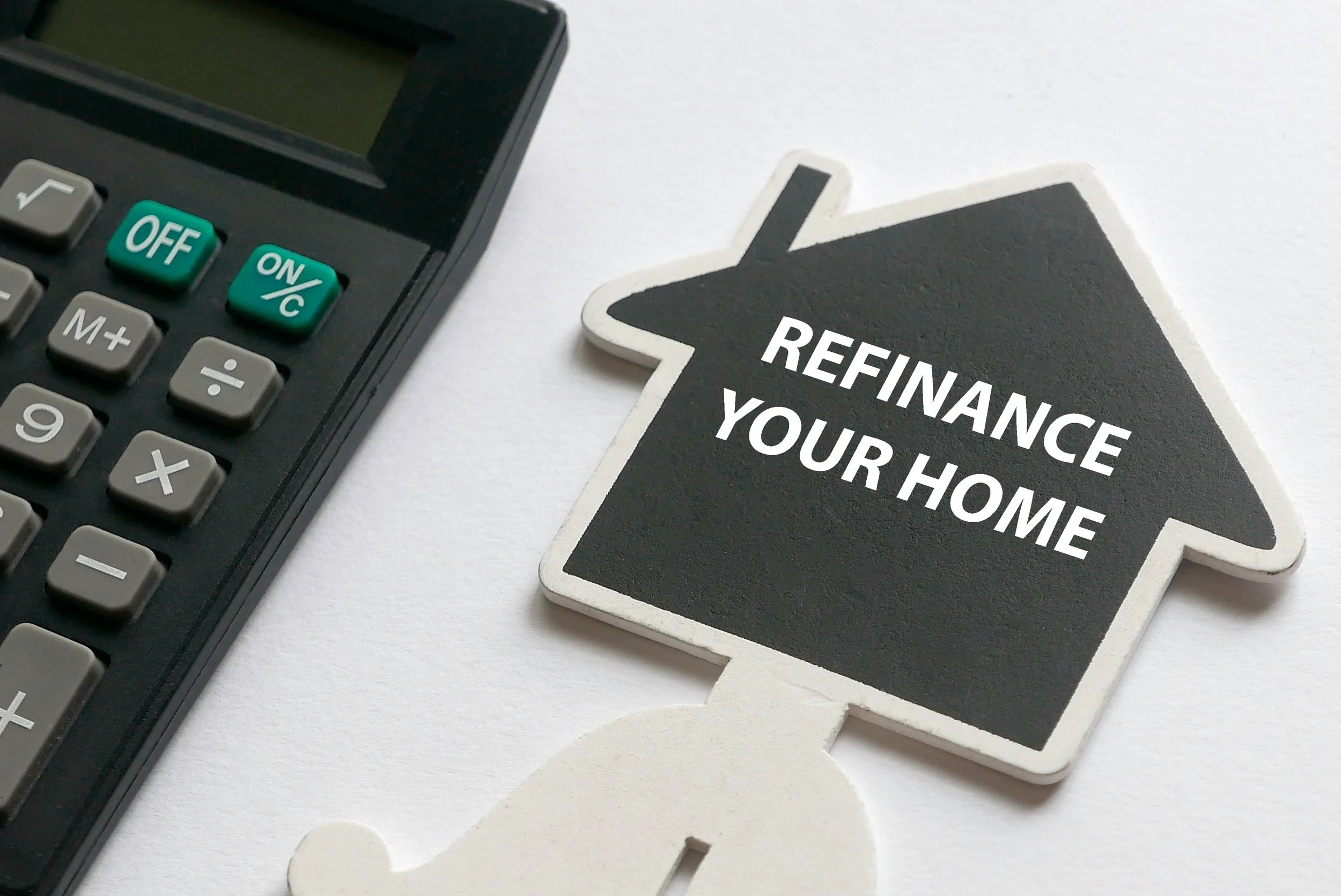 Refinancing a fully paid house in Malaysia concept with calculator and home icon showing refinance your home