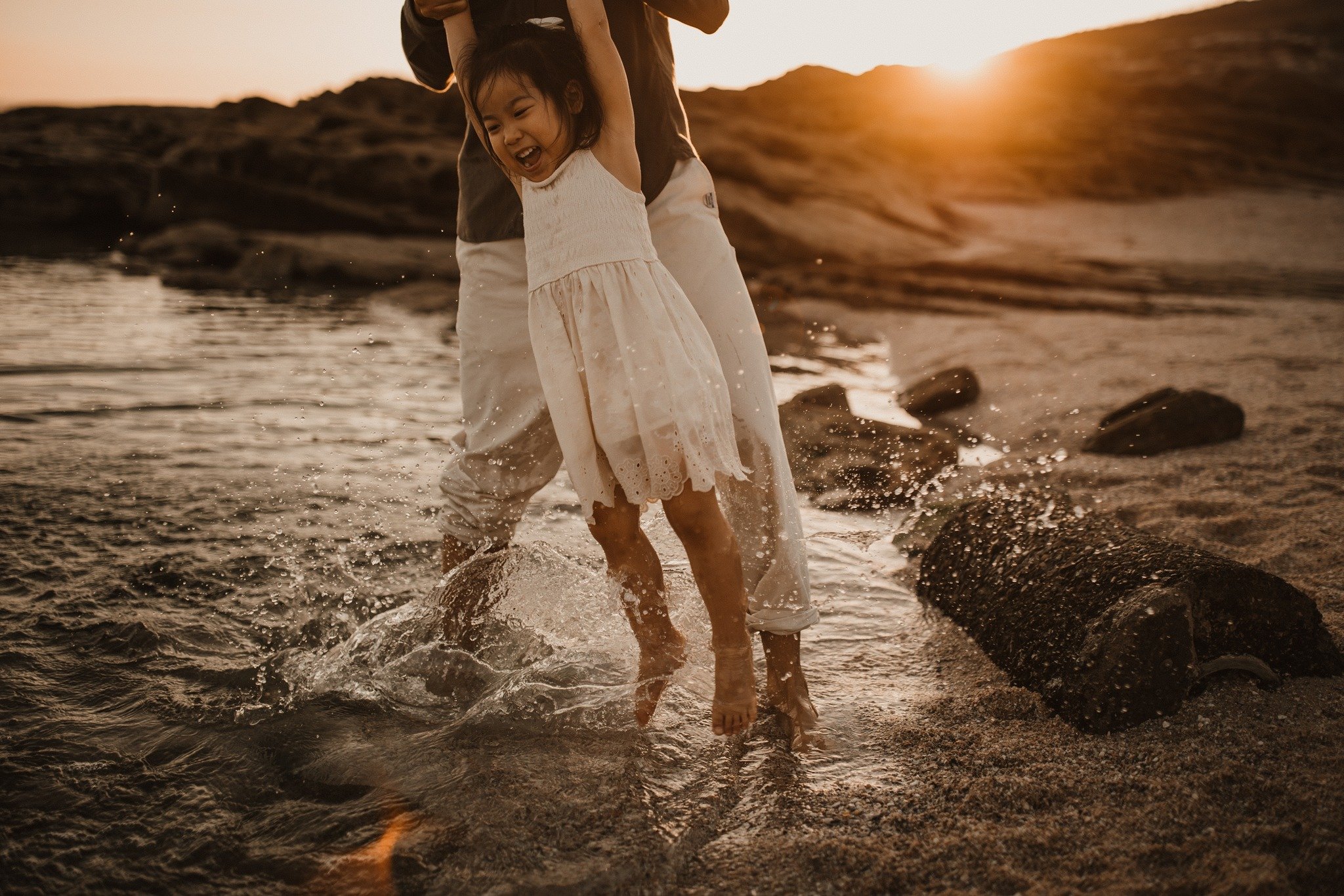 Pure joy on her face engrossed in playing with her dad. Not concerned about wet clothes or sandy feet, just pure enjoyment.

Bring a change of clothes to a session with me and allow your kids to be kids and not worry about getting their clothes wet o