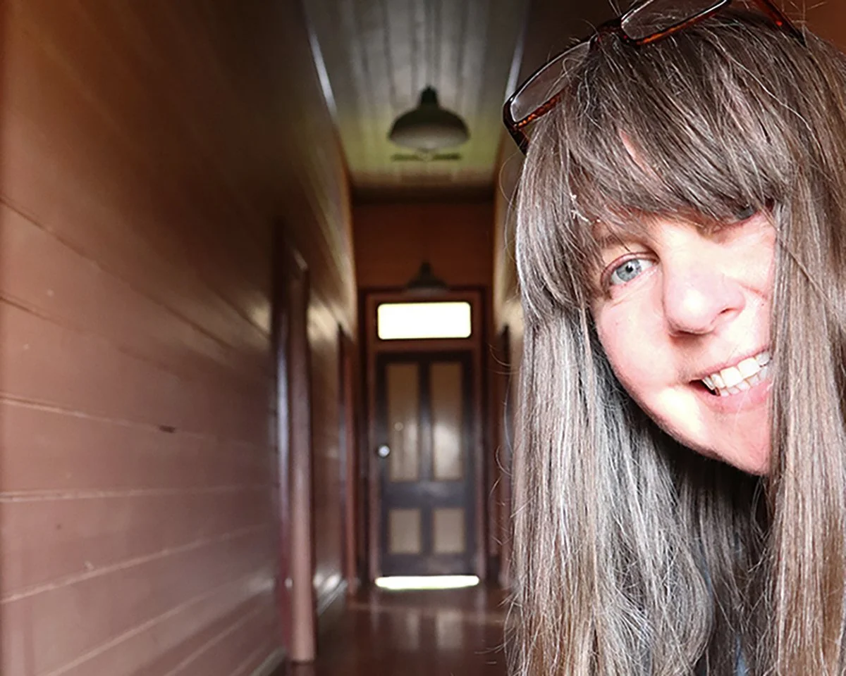 Nicola Mason peering around a door frame inside the Railway Hotel