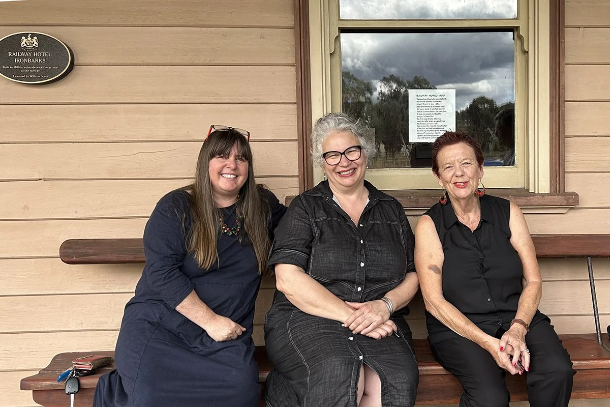 Nicola Mason, Alicia Leggett and Therese Wilkins sitting outside the Railway Hotel in Stuart Town
