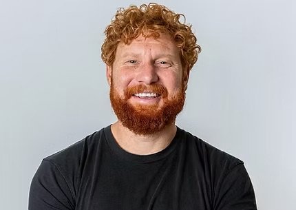 Portrait of comedian Ben Knight on a grey background