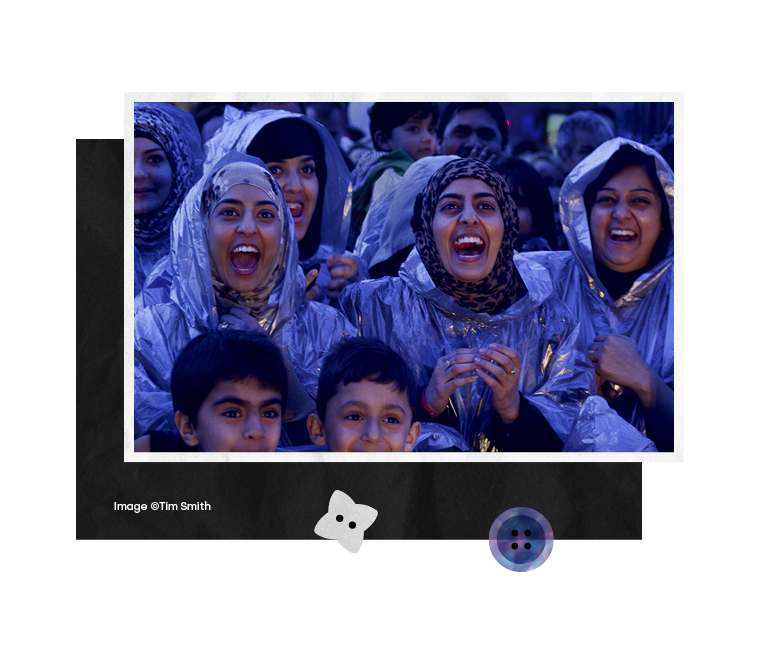  A group of three young women shout in delight at a live performance in City Park, close up image of four excited school boys during a Bradford Literature festival event, one boy turning enthusiastically to face his friend, A group of young women tak