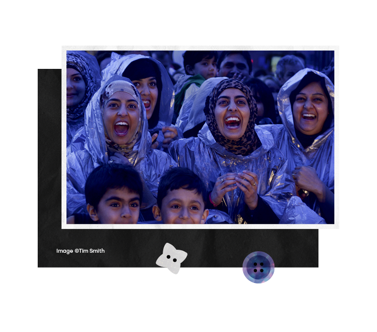 A group of three young women shout in delight at a live performance in City Park, close up image of four excited school boys during a Bradford Literature festival event, one boy turning enthusiastically to face his friend, A group of young women tak