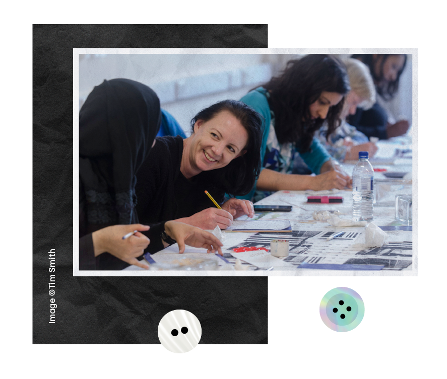  A group of women celebrating a family occasion at home, three young women in in glittering capes and make up smile at the camera during The Brick Box project in Marks and Spencer in Bradford, A young woman points enthusiastically at activity out of 