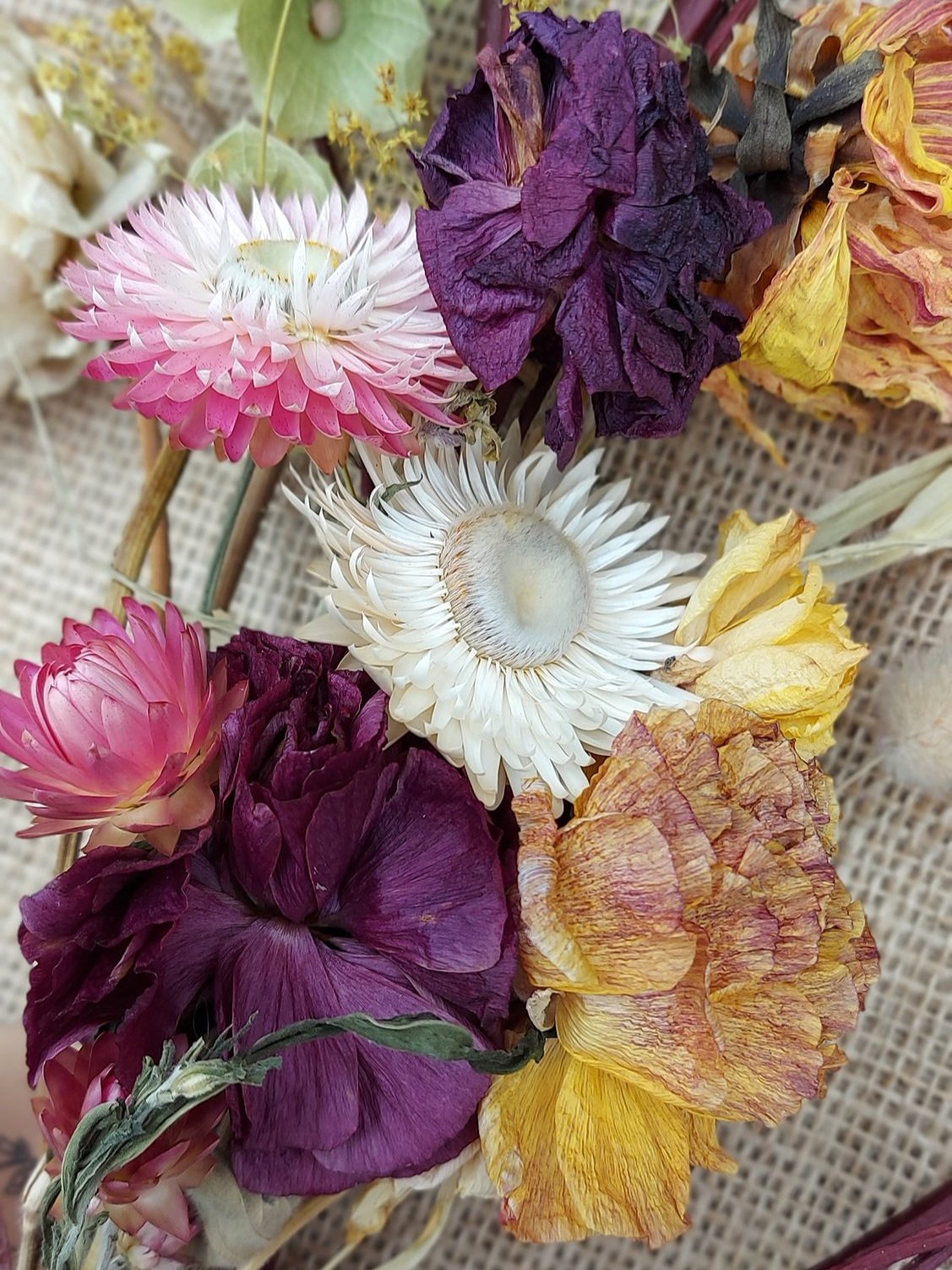 Dried flower heart wreath with green, pink, white, yellow and burgandy