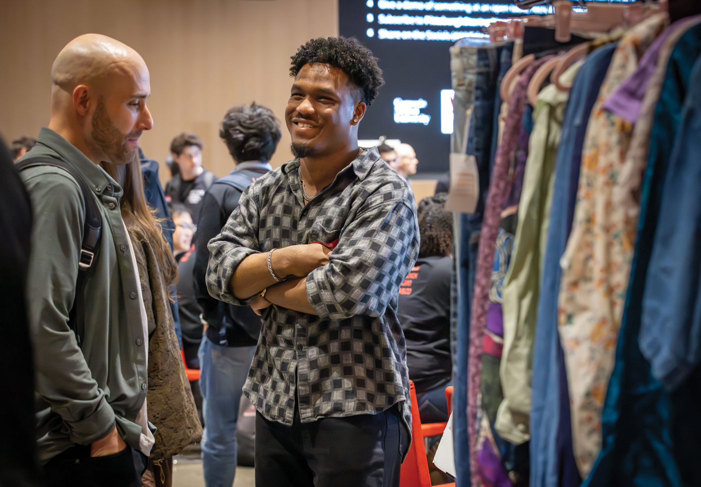 Paul Davis (right) of Thursday Thrift connects with one of 400+ AI//VS Demo Day attendees, who came to learn about the company and shop  its live pop-up.