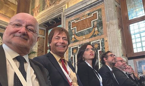 Alex Waibel (left), takes a selfie with some of the other members of Pope Leo XIV’s working group on AI guidelines at the Vatican.