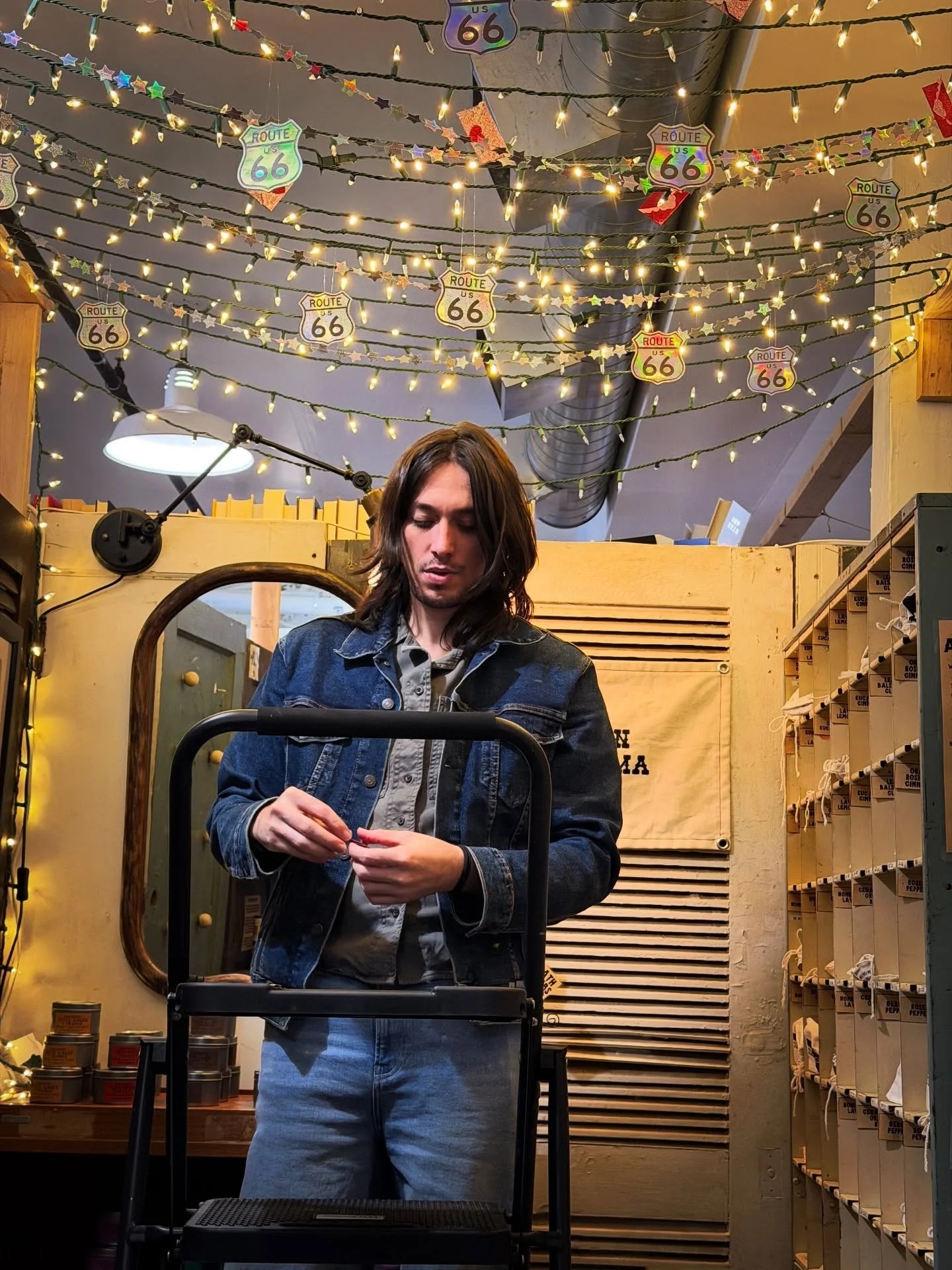 Adri hanging up all our lil handmade decorations! We love watching our booth evolve! We made some vvvv cute and shiny Route 66 signs to match our shiny stars for the centennial! We love any and every excuse to craft!!!