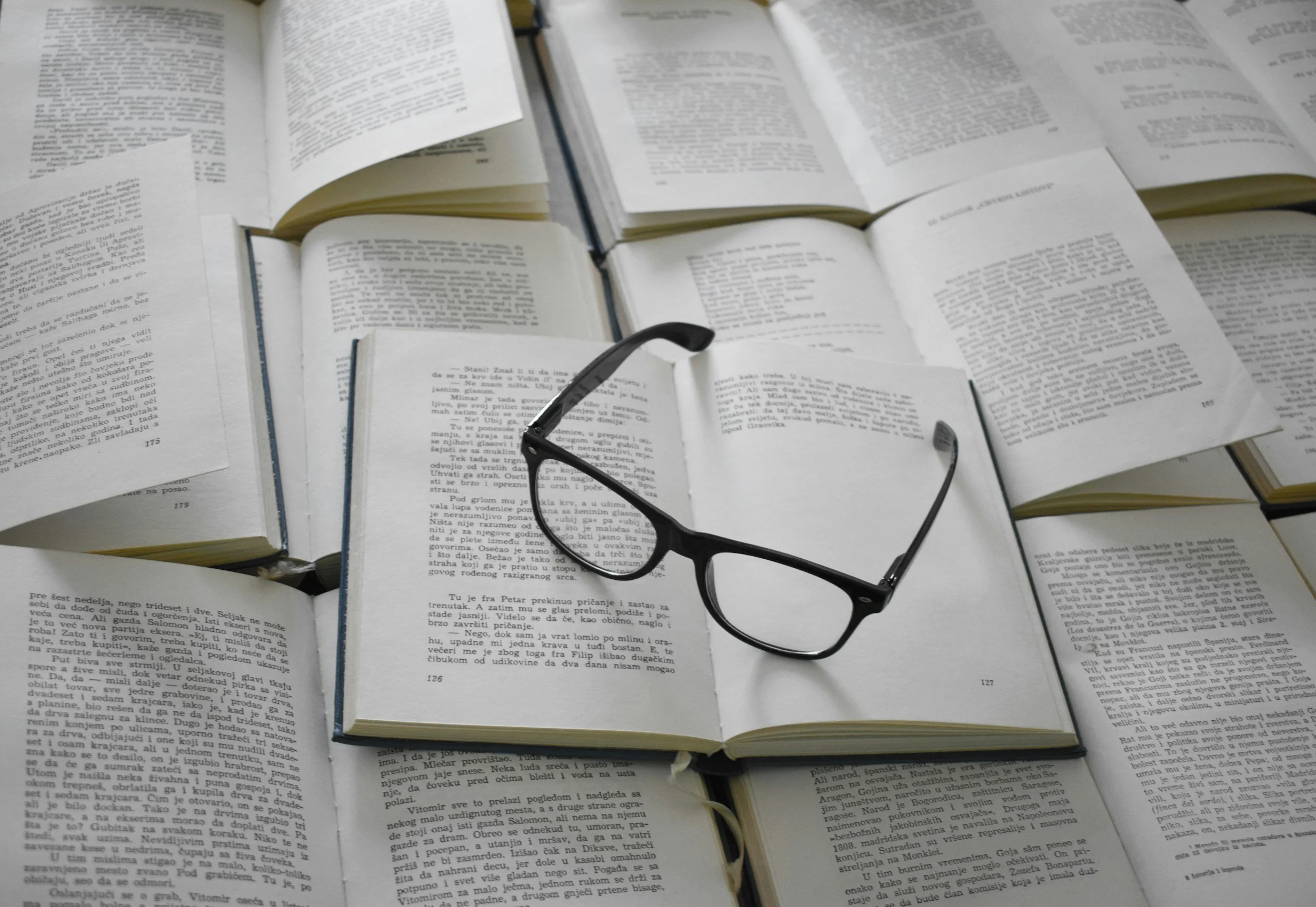 glasses sitting on open books