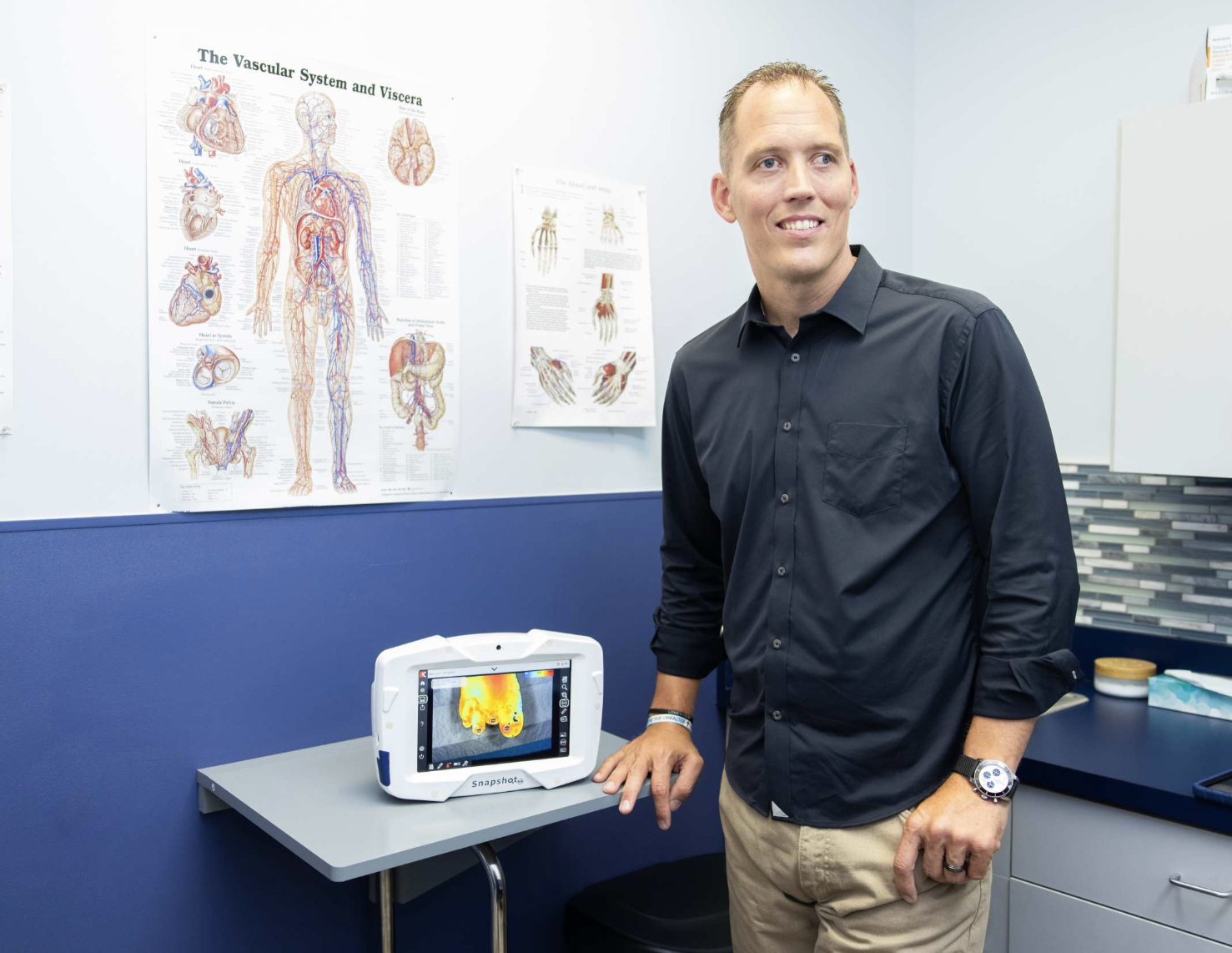 Tyler Sexton standing next to the SnapshotNIR device