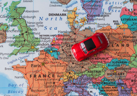 Map and small red car near europe