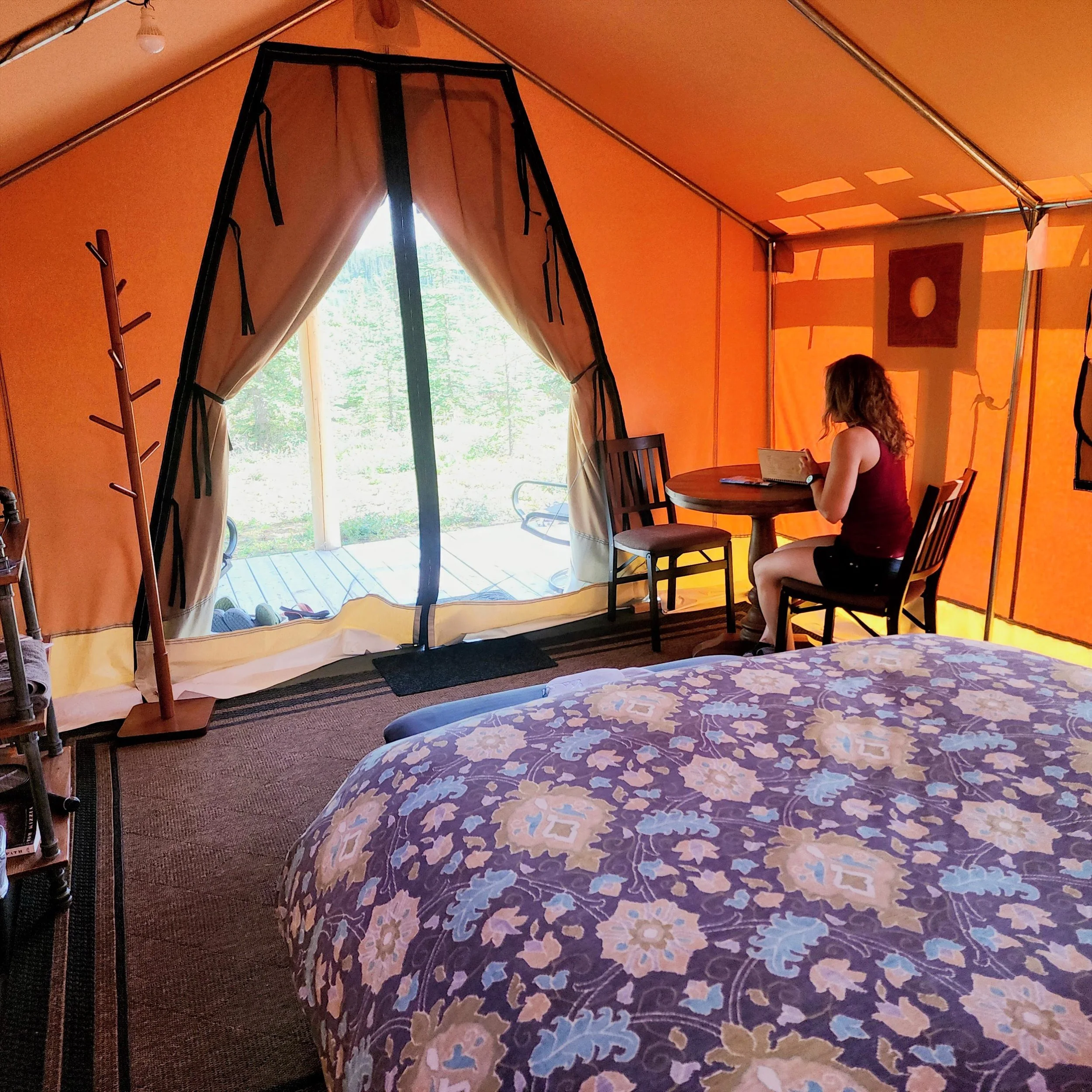Guest sitting at table writing in guestbook.
