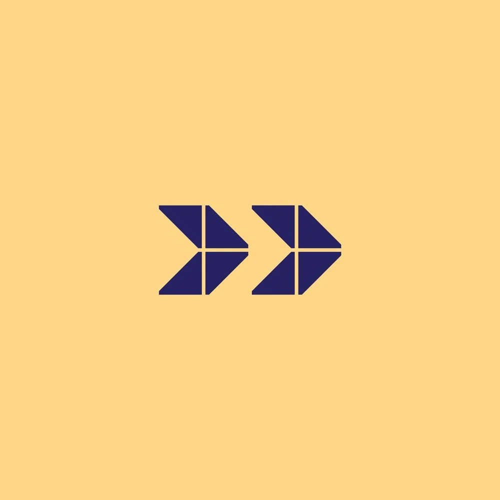 Two stylized navy blue arrow symbols pointing to the right on a light beige background.