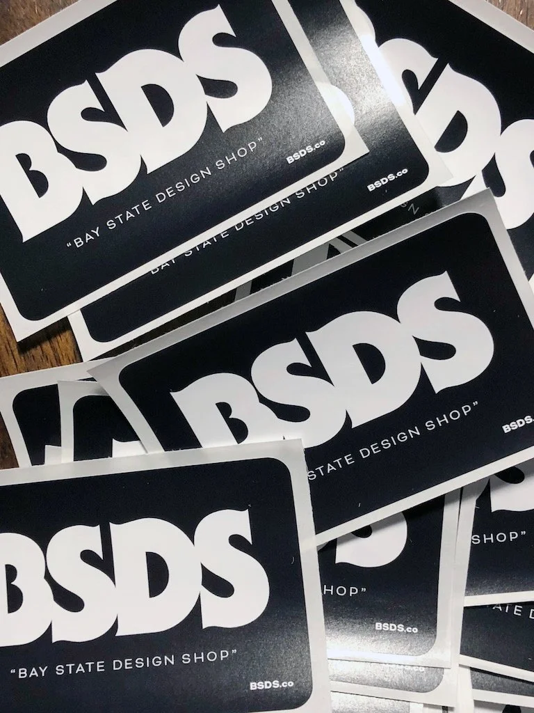 Multiple black and white stickers displaying the text 'BSDS' for Bay State Design Shop.