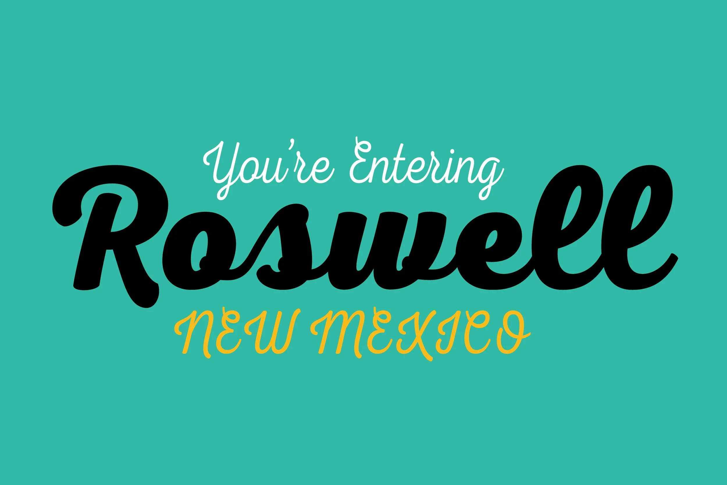 Sign with teal background that reads, "You're Entering Roswell New Mexico" in stylized white, black, and yellow text.