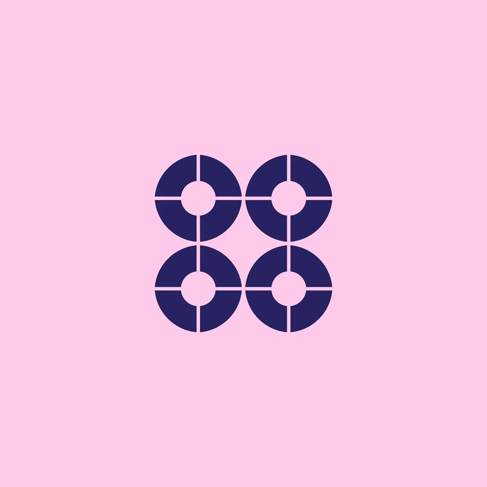 Four navy blue circles divided into four segments each, arranged in a 2x2 grid, on a pink background.