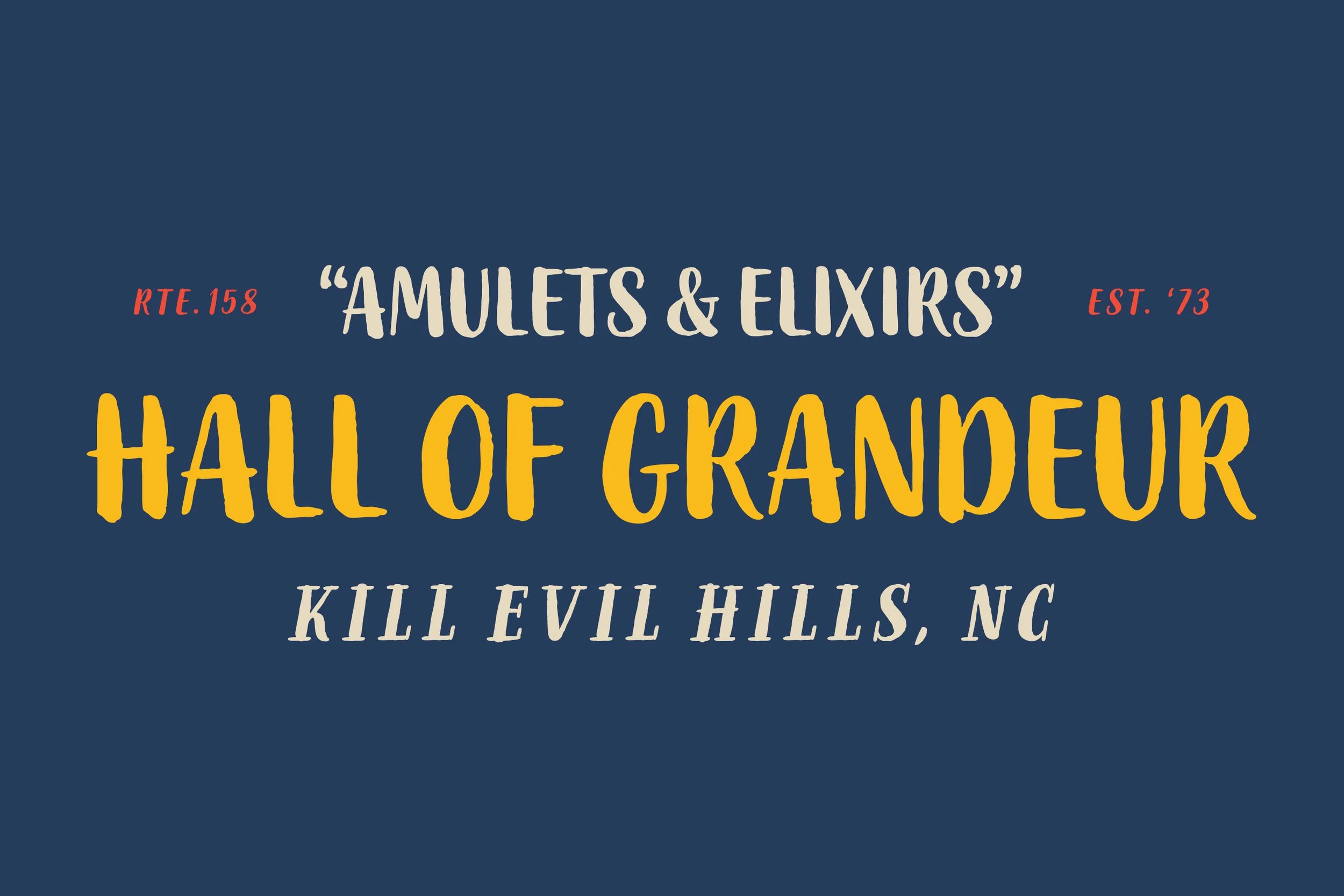 Sign for Amulets & Elixirs, Hall of Grandeur, located at Kill Evil Hills, NC, established in 1973, with a dark blue background and text in beige, red, and yellow.