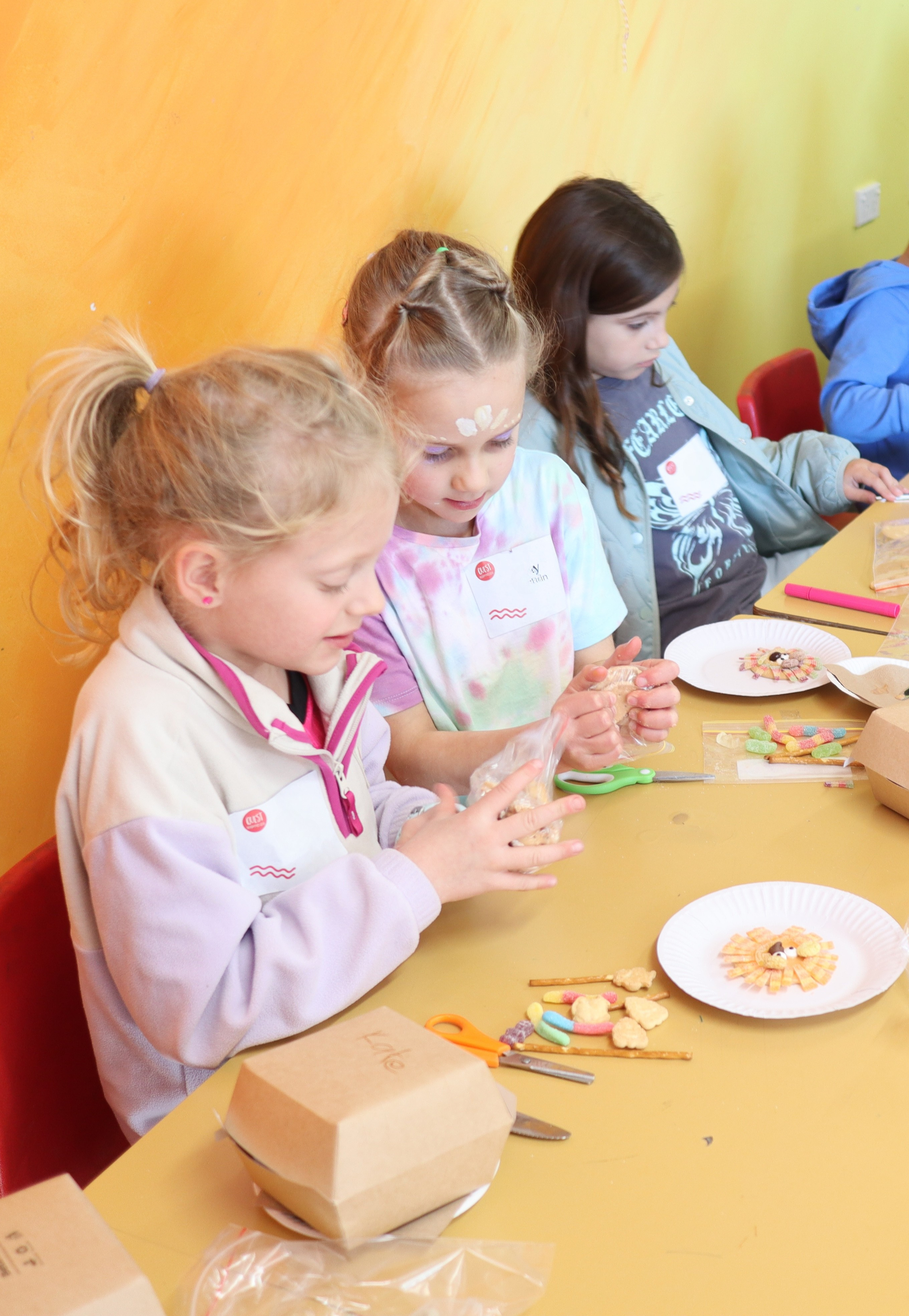 Three children doing a craft activity