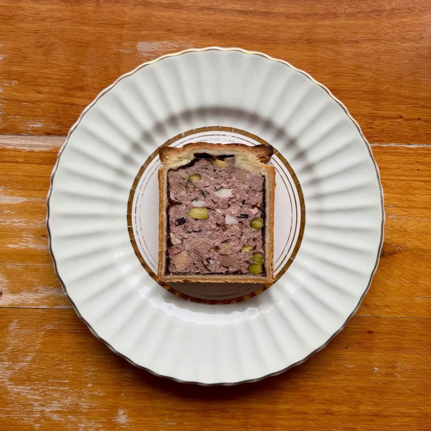 &ldquo;P&acirc;t&eacute; en Cro&ucirc;te&rdquo; of Rose Veal, Berkshire Pork, Ox  Tongue, Trompette Mushrooms &amp; Pistachio. 
Finished with a fine Aspic of Ham Hock &amp; Brandy.

Served by the slice with Tarragon Mustard &amp; Cornichons. 

Top Te
