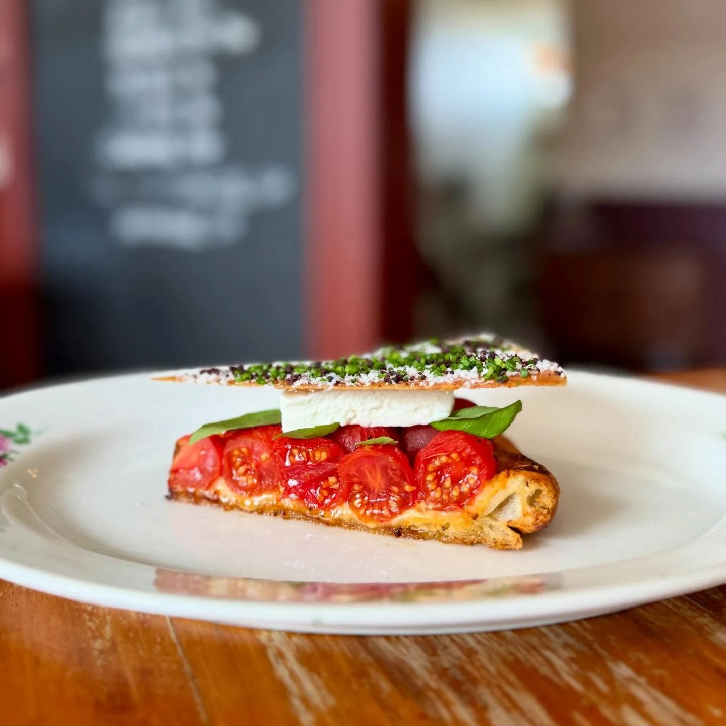 Warm Tomato Tart, Ch&egrave;vre &amp; Basil.

Peeled sugarplum tomatoes set into a warm Comte fougasse lined with sesame, cumin &amp; poppyseed. Topped with a slice of Meredith Ch&egrave;vre and a Parmesan wafer dressed in salted ricotta &amp; dried 