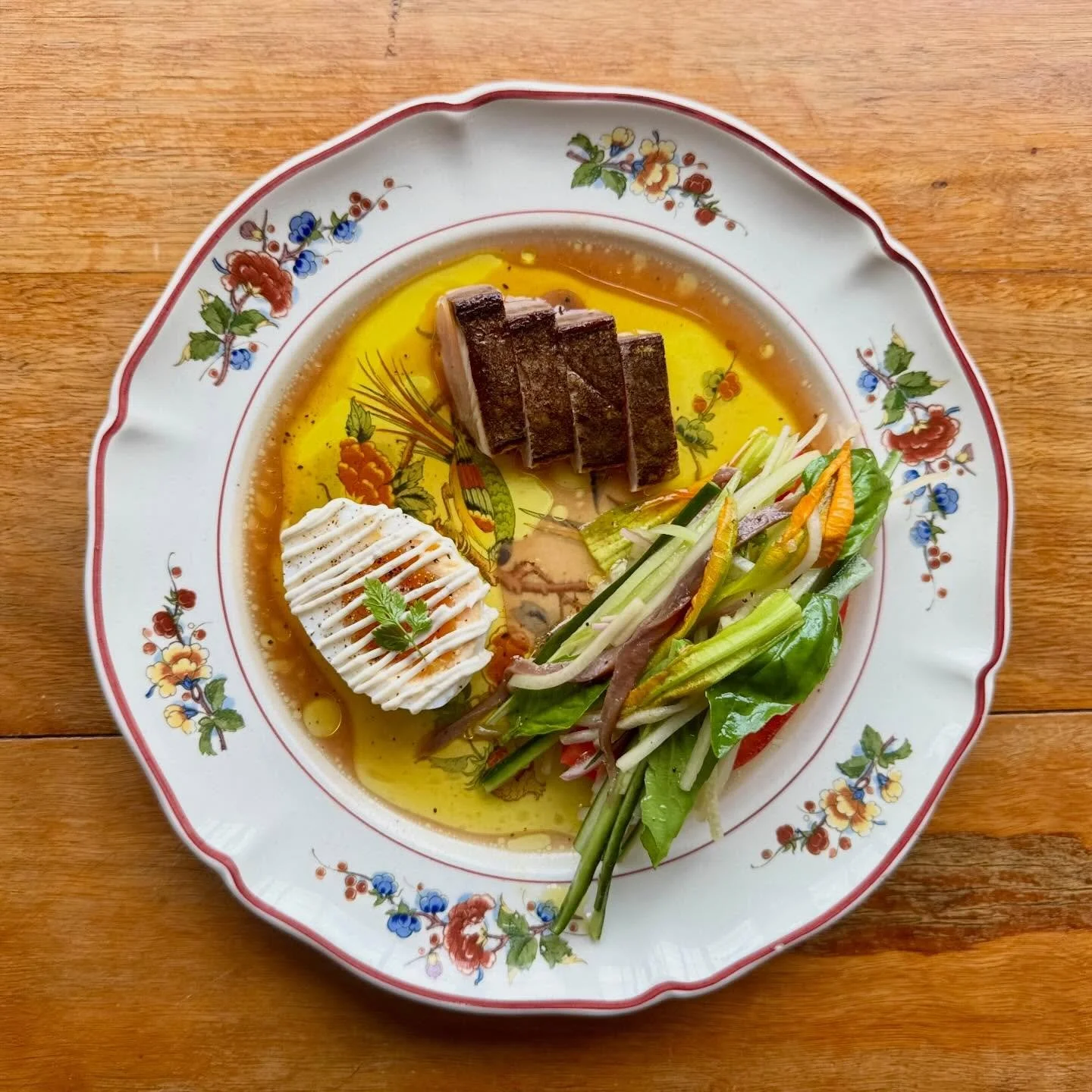 &ldquo;Salade Riviera&rdquo; 
A delightful fresh salad of thick cut ripe tomato with finely sliced cucumber, celery, shallots &amp; anchovies, zucchini flowers &amp; basil dressed in red wine vinegar, lemon juice and lots of olive oil. Finished with 