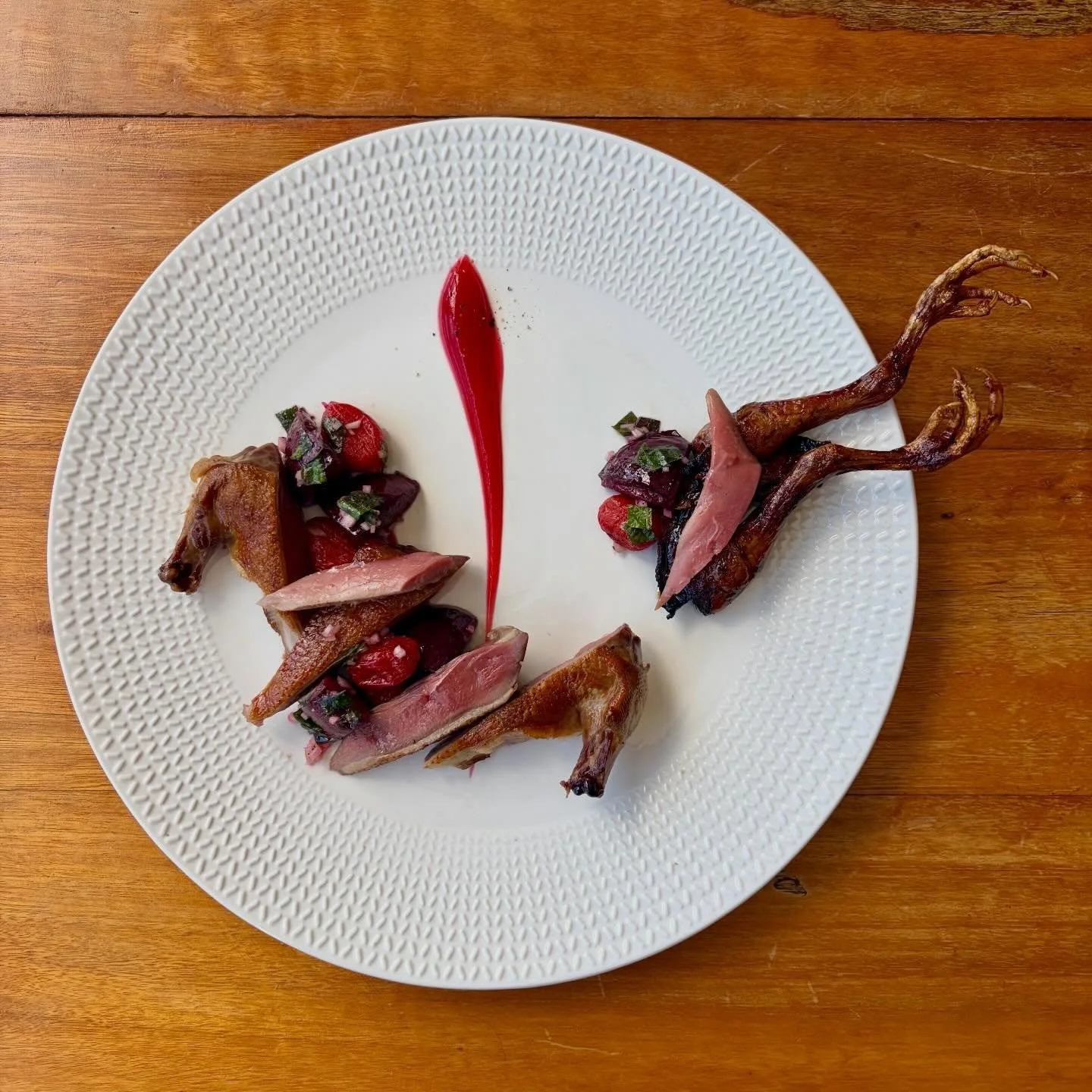 Pigeon &ldquo;Grill&eacute; et Laqu&eacute;&rdquo; 
Cooked Whole over the BBQ and glazed in Cherry Blossom Honey. The Neck Sausage with Lardo, Black Pepper &amp; Pigeon Livers. Served  with Dried Cherry Tomatoes, Garnet Plums warmed in Smoked Pigeon 