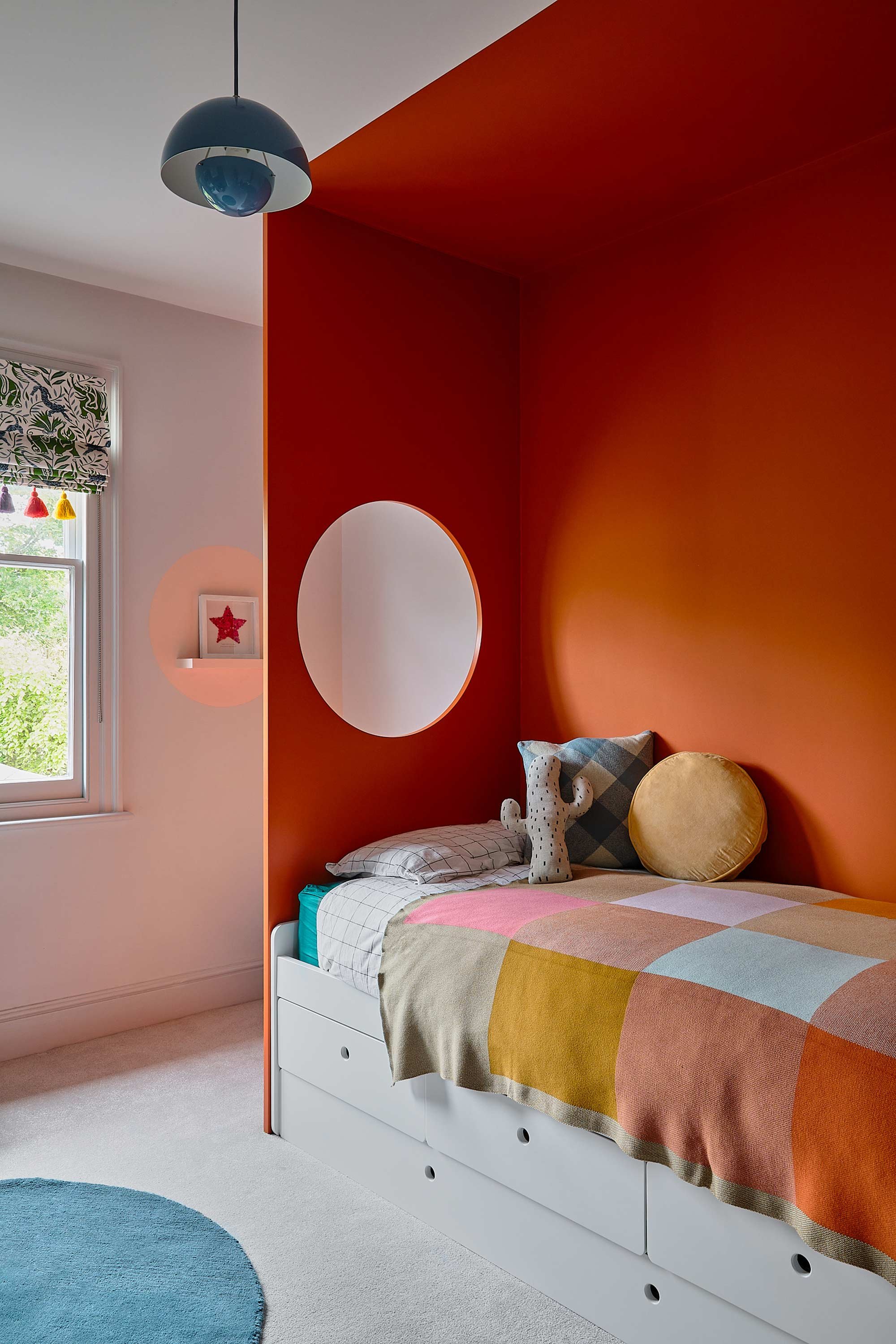 custom-made-bed-area-with-orange-wall-on-drawers.jpg