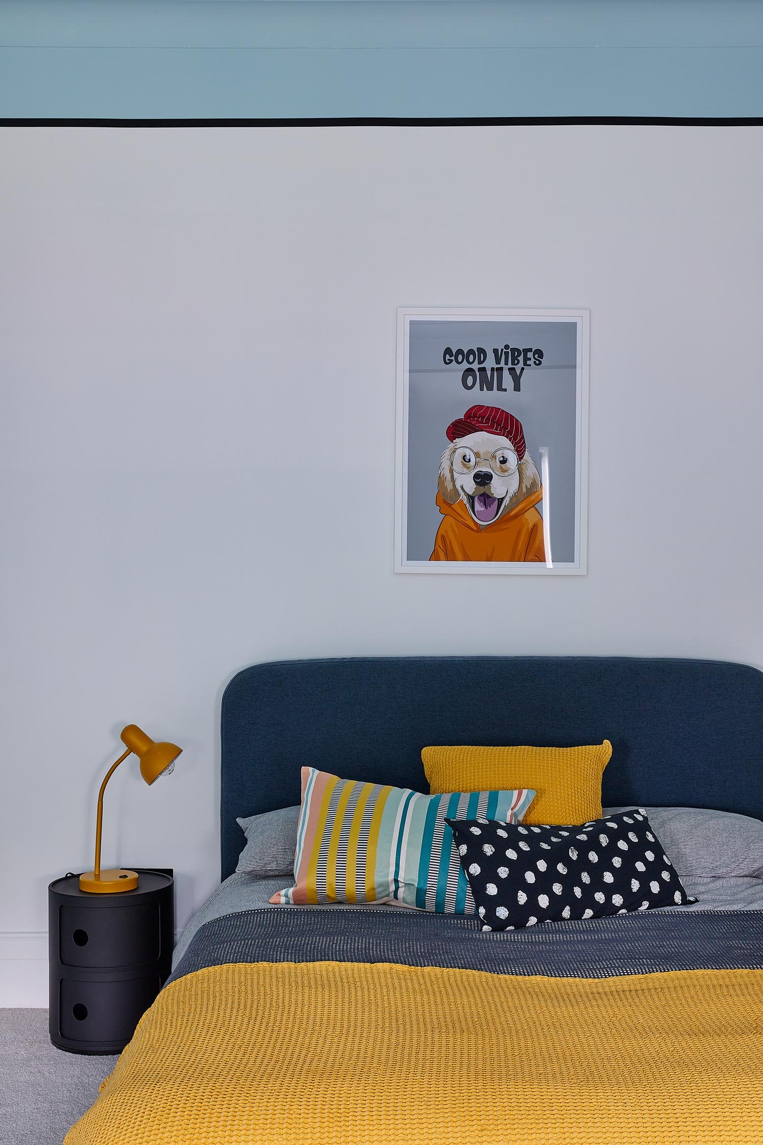 dog-poster-above-yellow-and-blue-bed.jpg