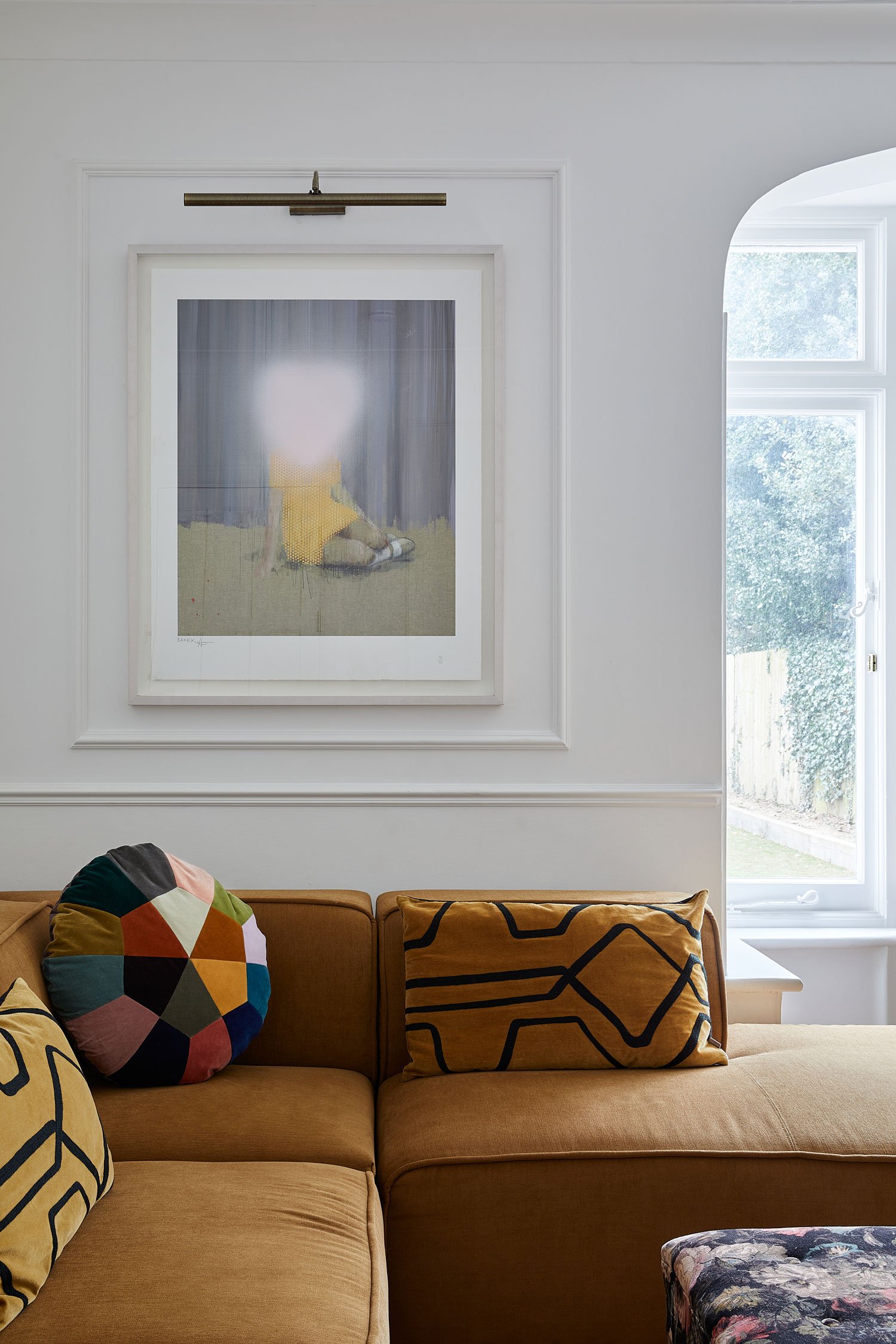 framed-picture-above-honey-colour-corner-sofa.jpg