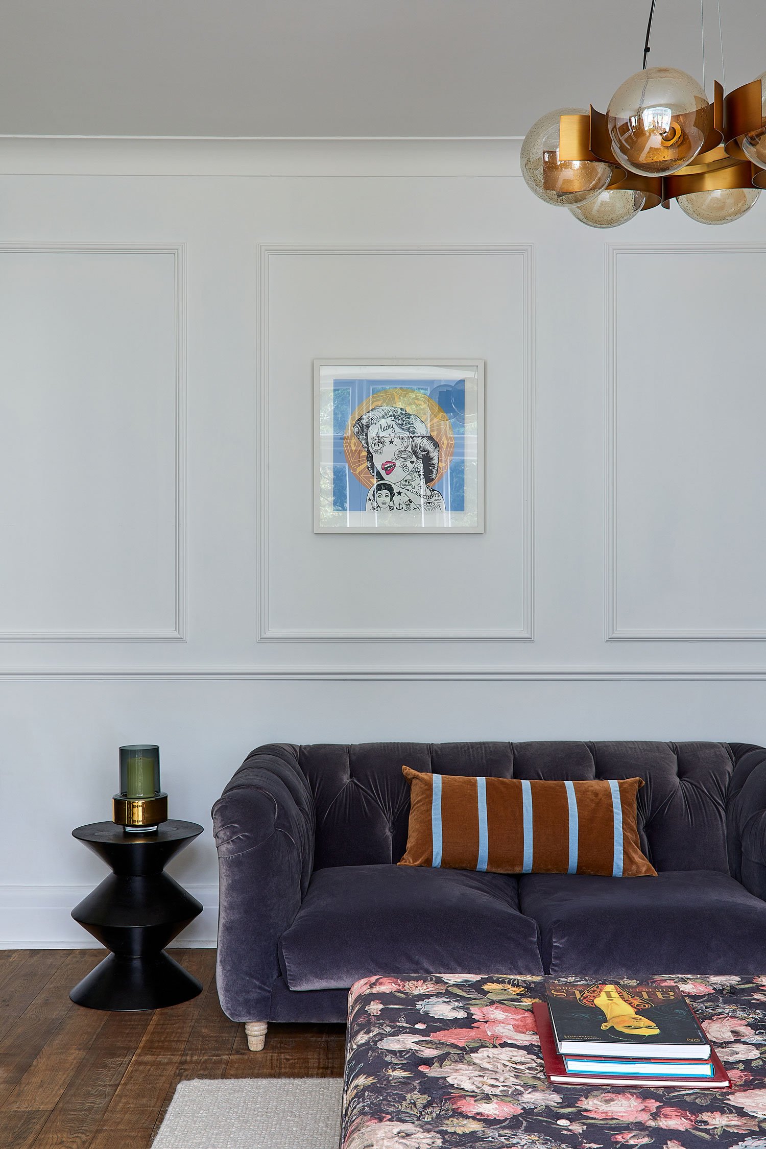 framed-picture-on-white-wall-above-grey-velvet-sofa.jpg