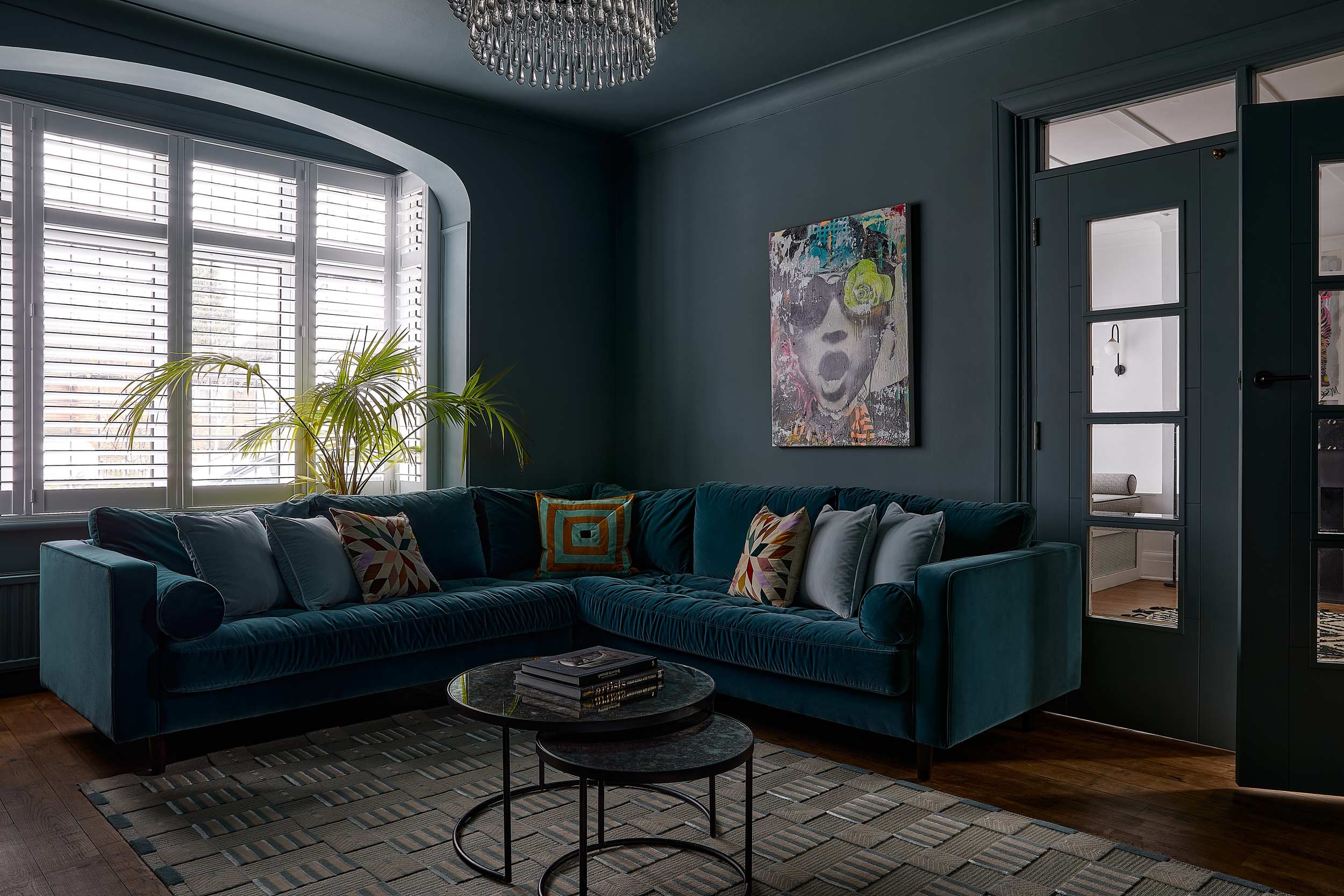 teal-corner-sofa-against-window-and-grey-walls.jpg