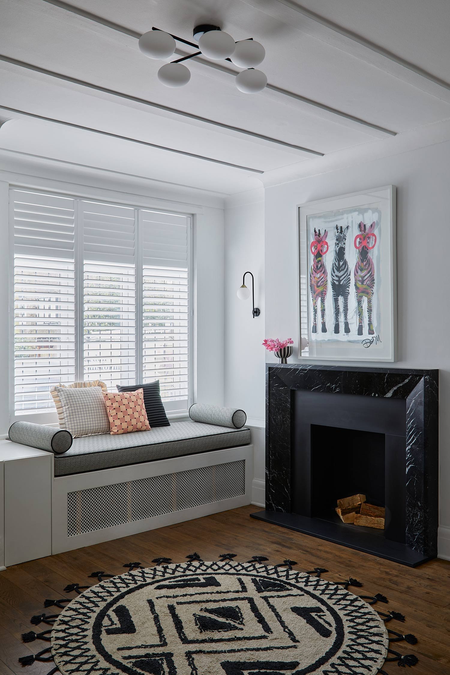 window-seat-with-framed-picture-above-fireplace.jpg